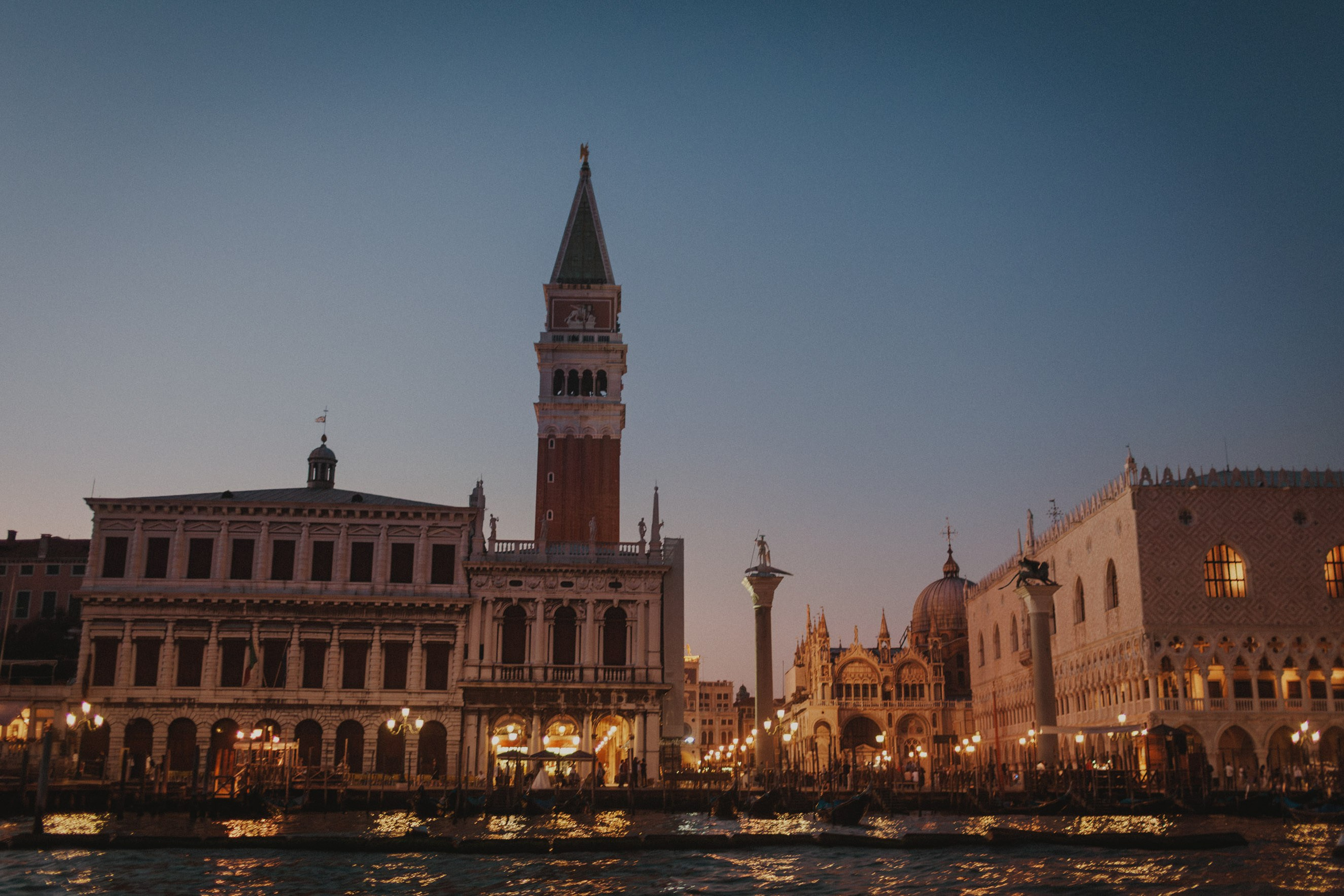 San Marco and the Doge's Palace are photographed from a boat as the sun sets in Venice.