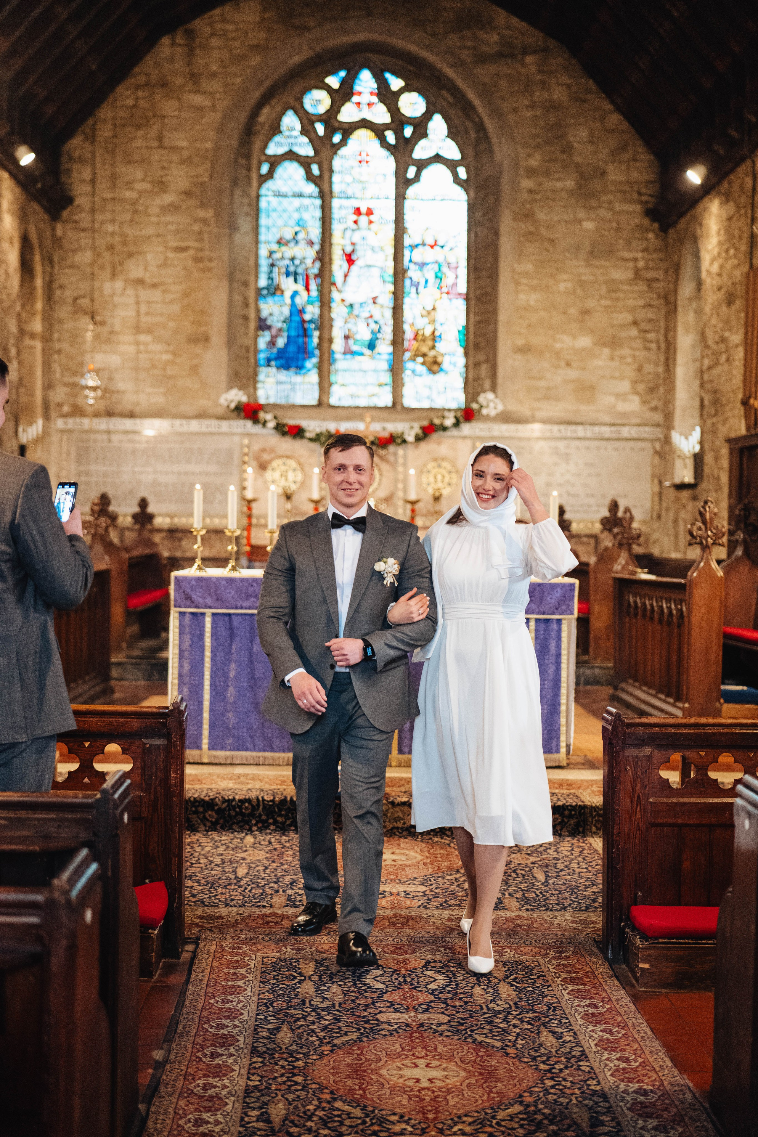 bride and groom leaving a church after the wedding ceremony