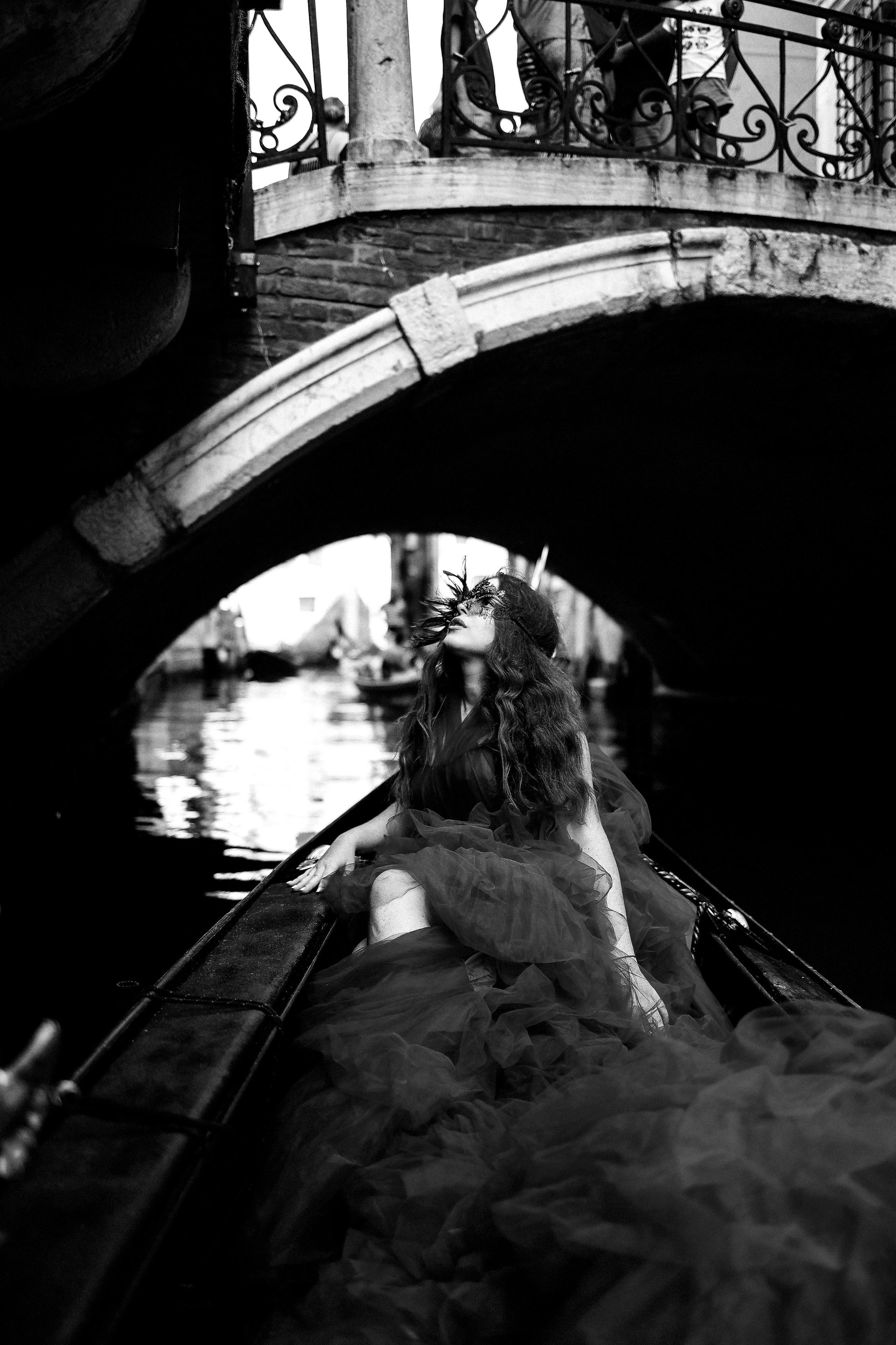very beautiful photo of a girl in a mask in gondola
