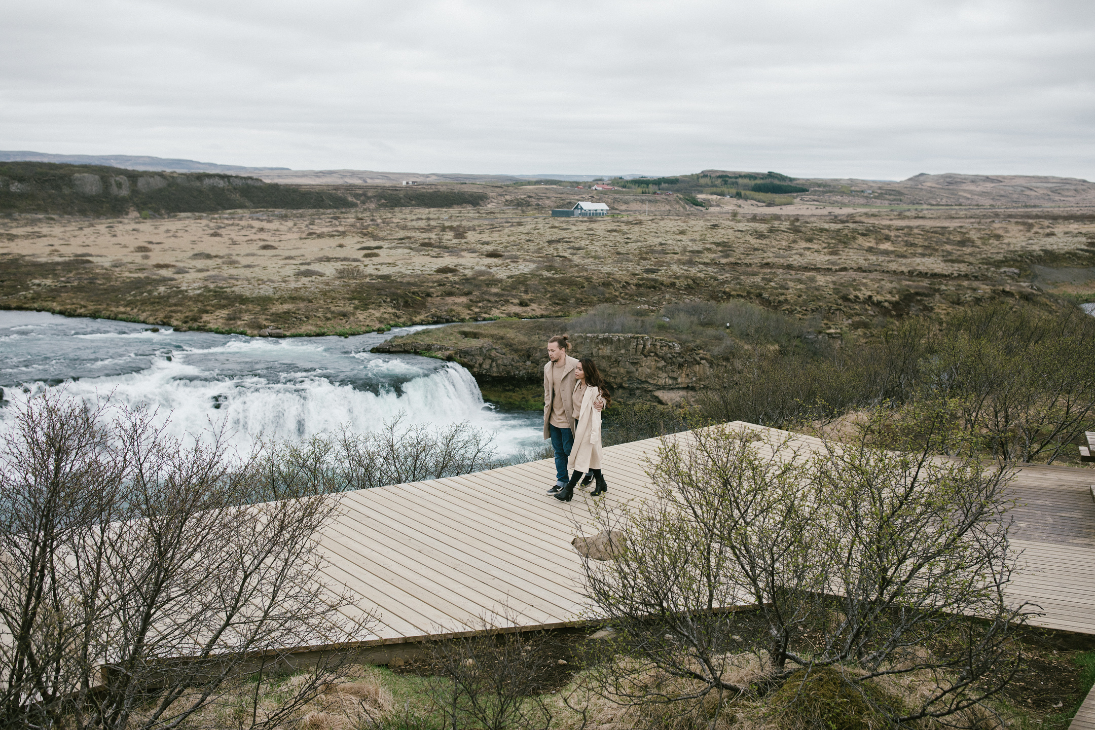  Iceland elopement couple walking by remote waterfall