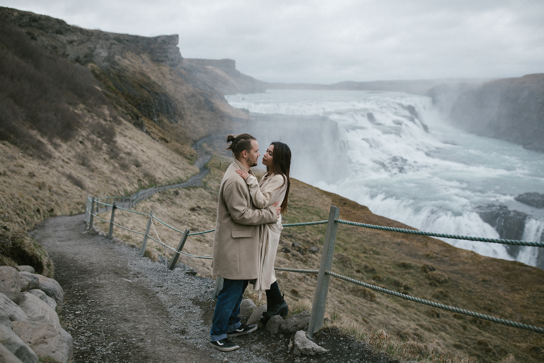 Couple hugging at Gullfoss waterfall during wedding photography in Iceland