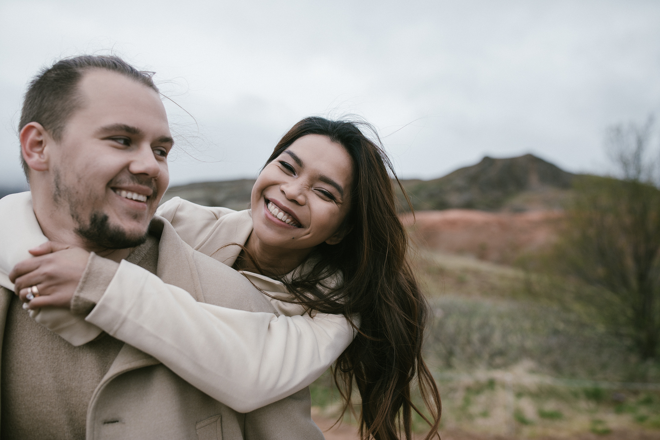Playful engagement photography piggyback in Iceland countryside