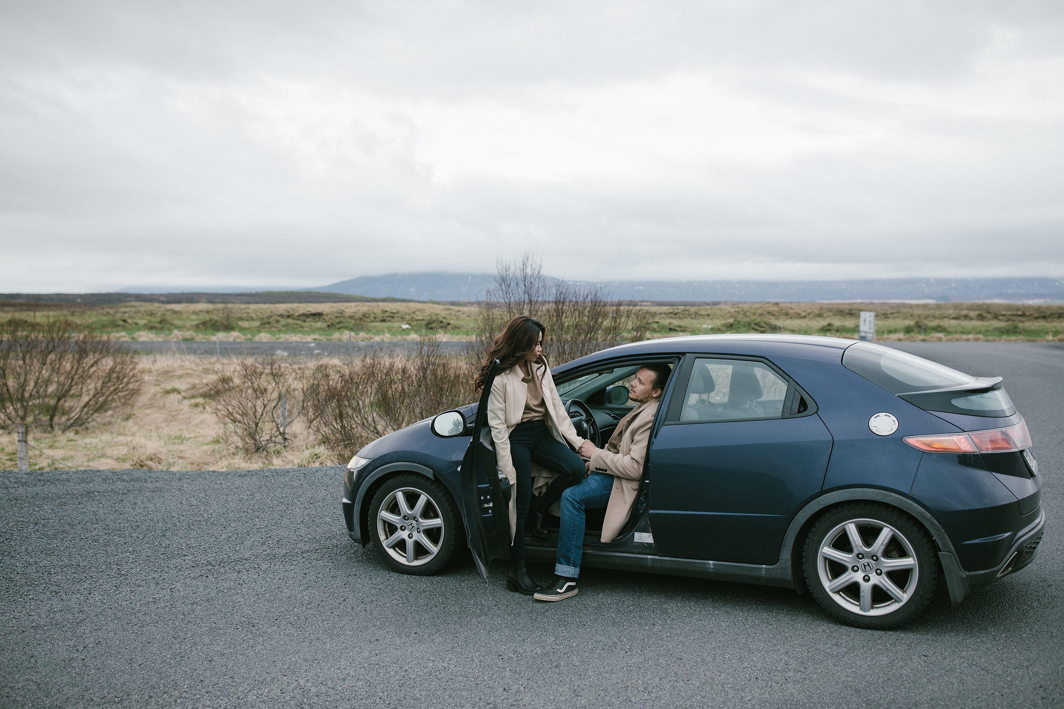 Romantic Iceland elopement road trip moment by the car