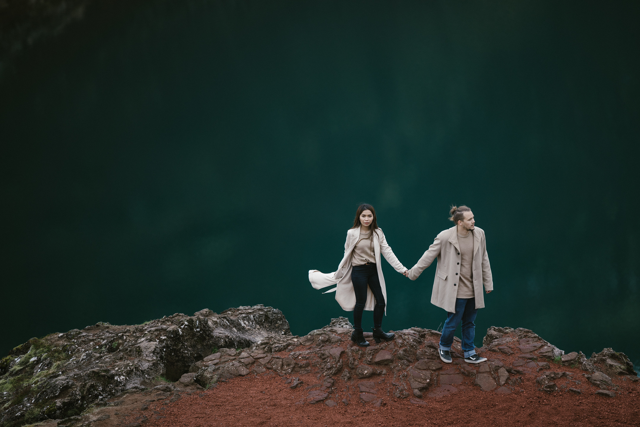 Couple holding hands during Iceland engagement photo session