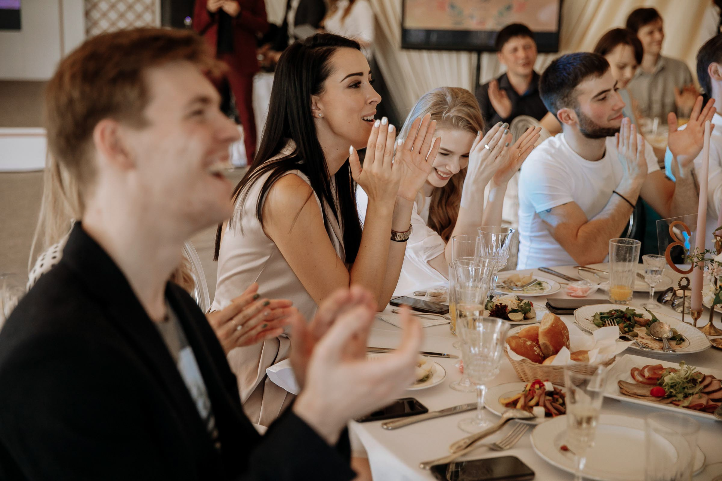 Laughing guests at reception, by Tanya Bodgan, Bude wedding photography.