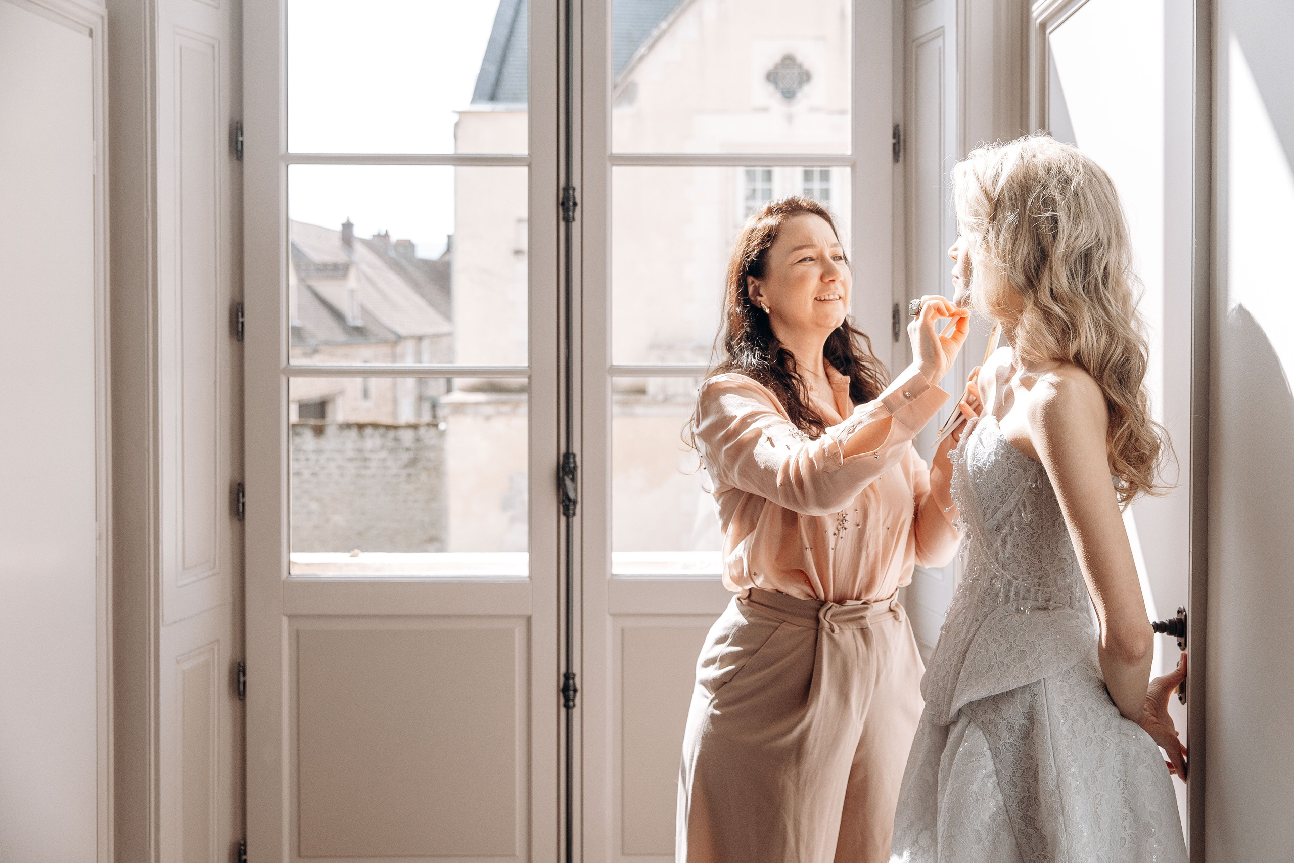 Candid shot of the bride getting ready for her wedding ceremony in France. 
