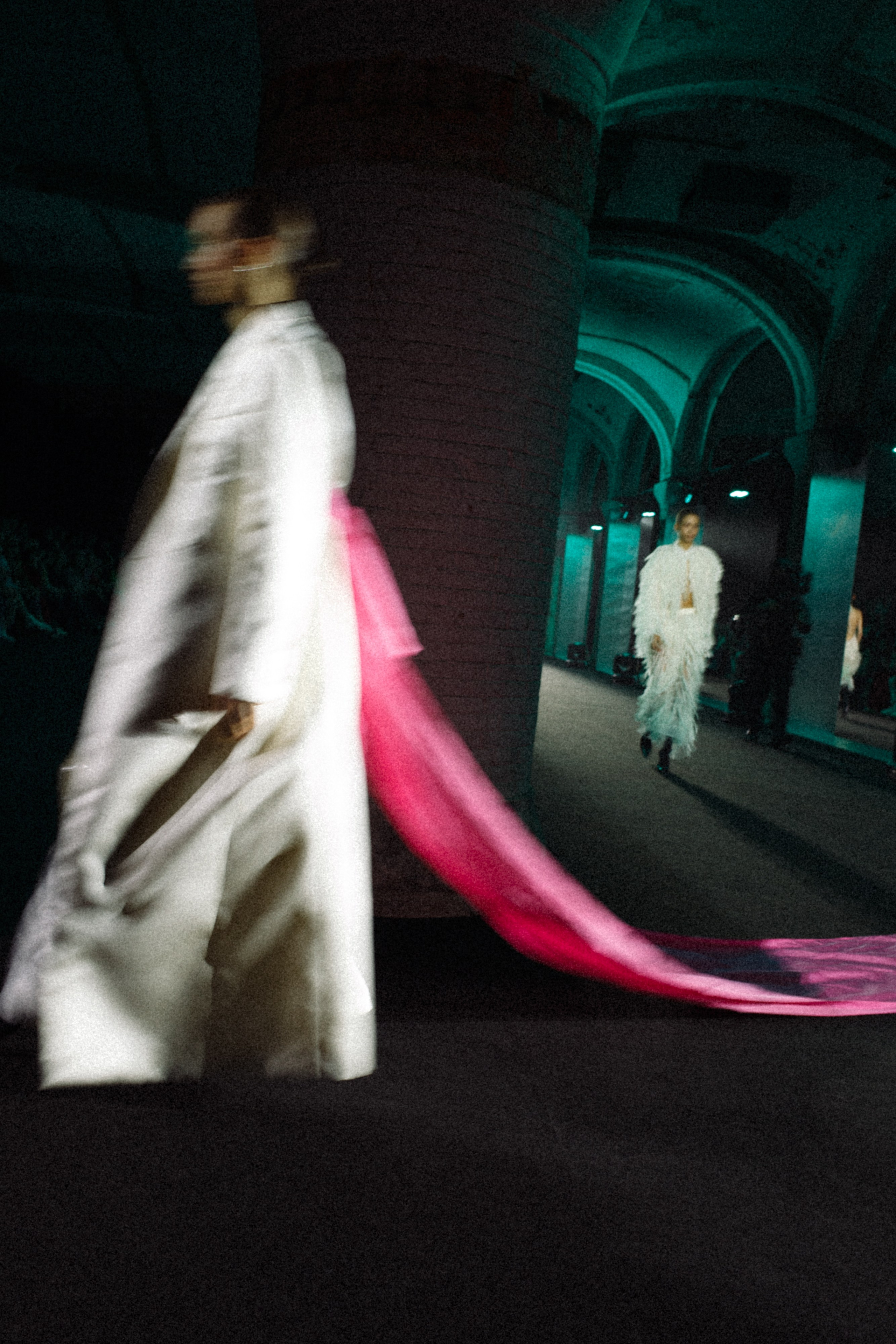 A fashionably dressed person in motion with dramatic lighting and blur