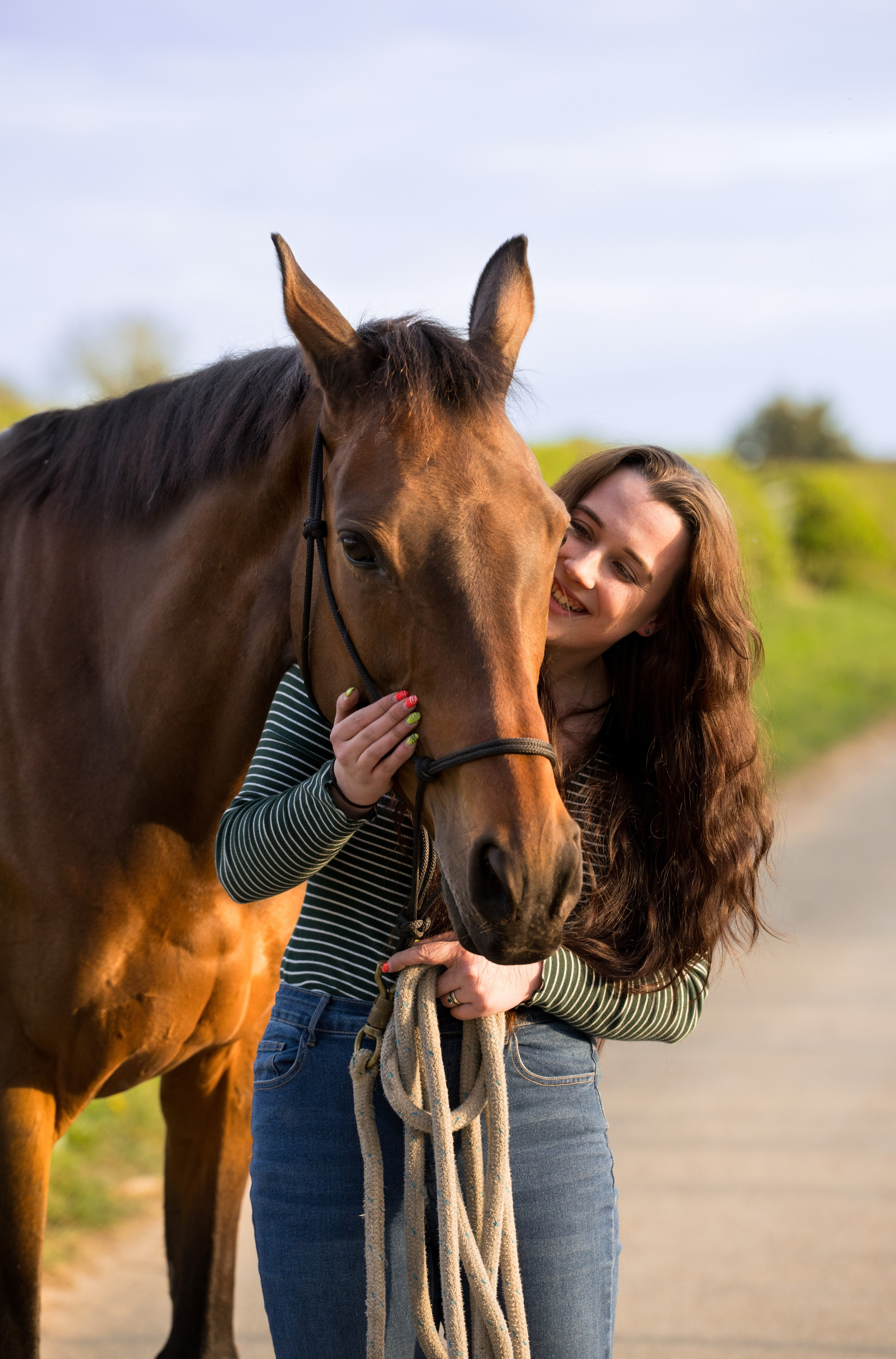 Horse and teen posing together during golden hour equine photoshoot in Leicestershire