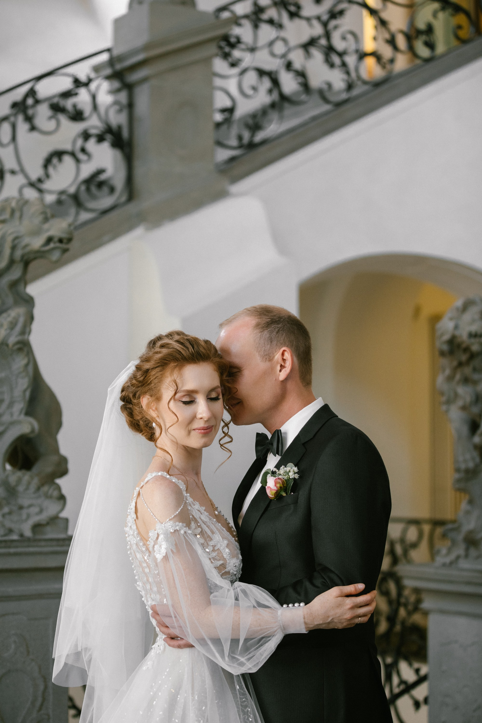 Emotional wedding portrait by staircase at Neues Schloss Meersburg