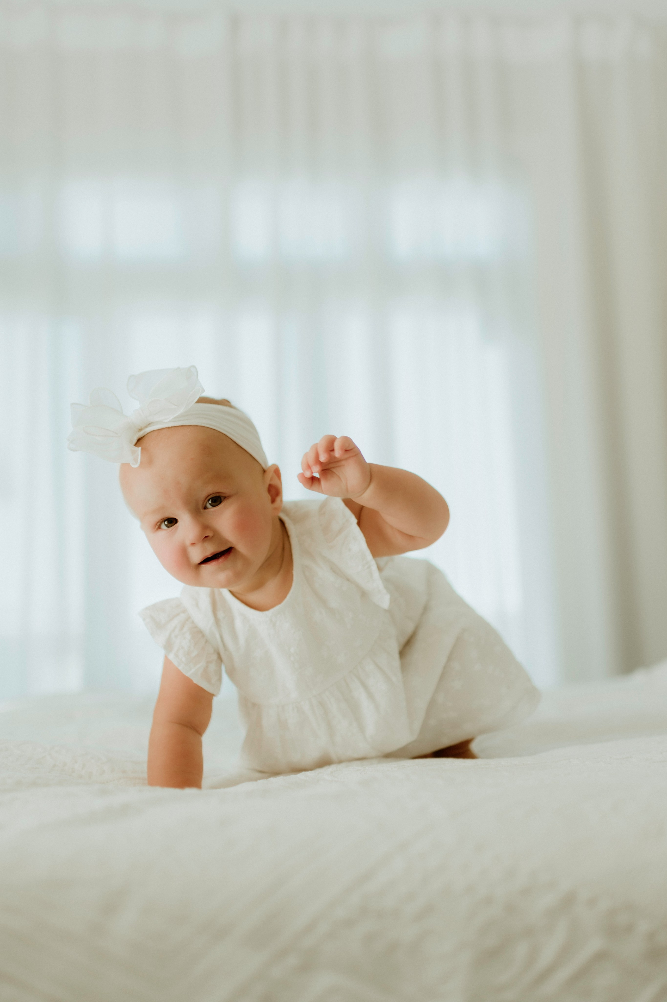 An enchanting outdoor maternity photoshoot at the client's house. The image features a radiant mother and her daughter, both elegantly dressed in white, against the backdrop of their home. The simplicity of their attire and the natural surroundings creates a timeless and intimate atmosphere. Book a personalized outdoor session with MD Studio to capture beautiful moments in the comfort of your own home