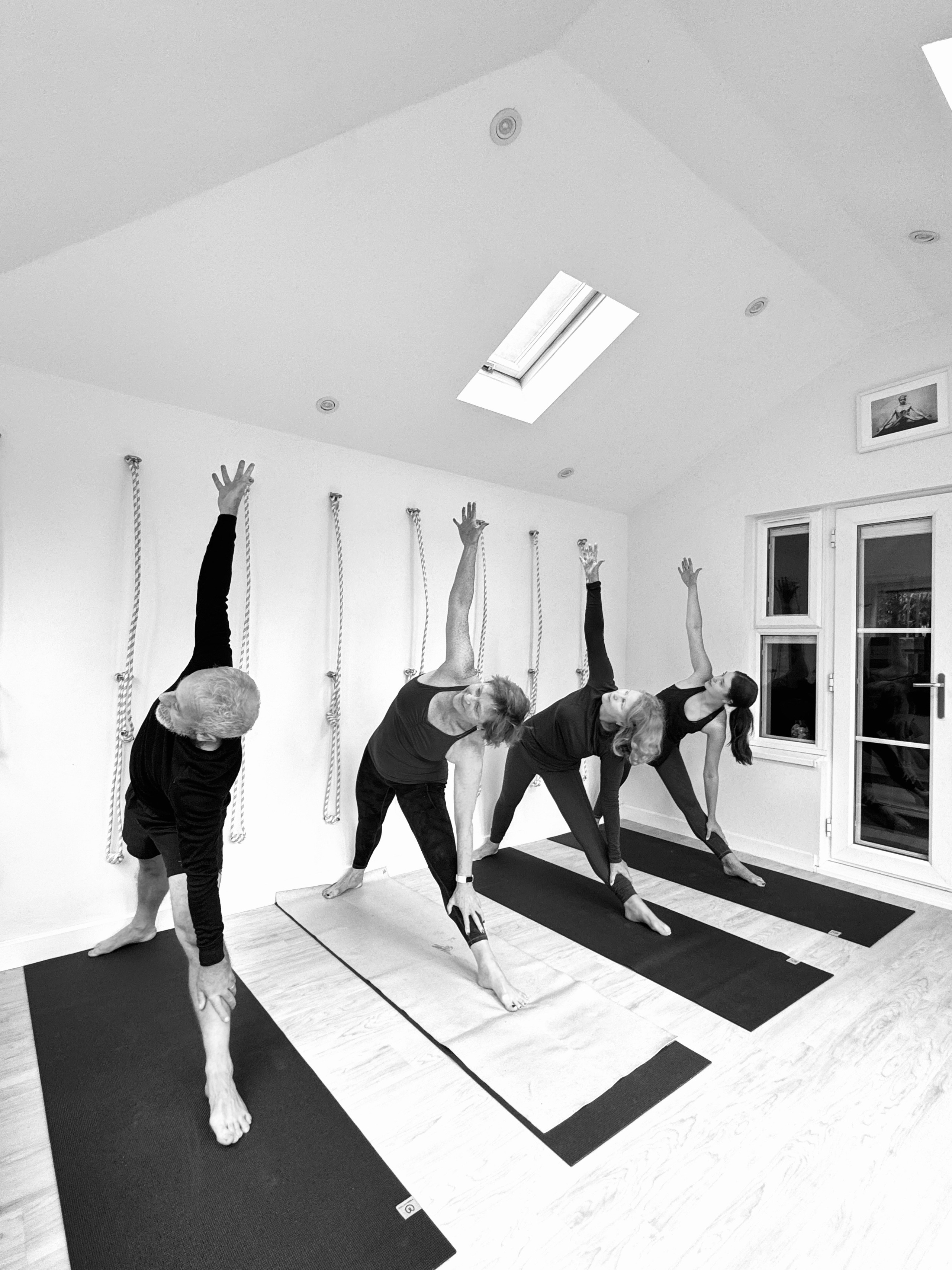 Solihull Iyengar yoga class, small group practicing precise postures in a bright, peaceful studio.