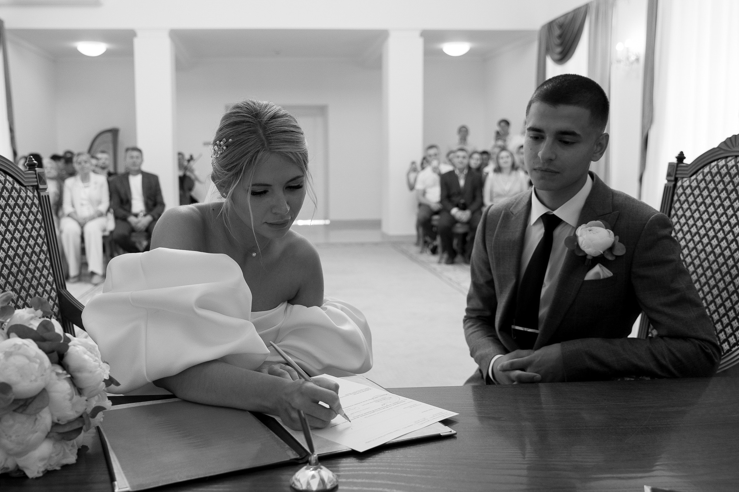 Couple signing register, by Plymouth wedding photographer.