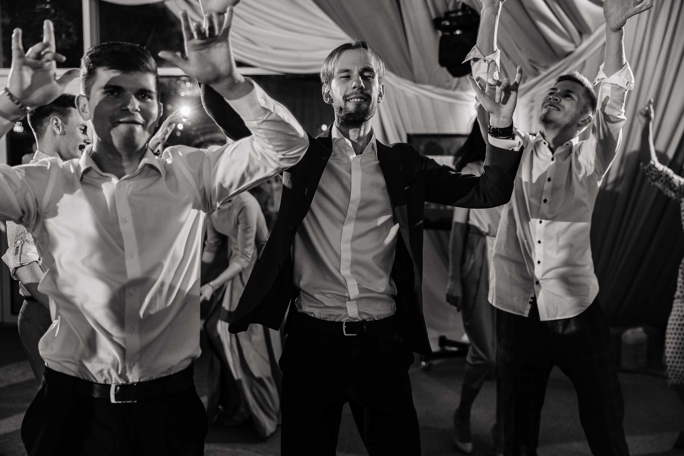 Groomsmen dancing candid, by Tanya Bodgan, Bude, Cornwall wedding photography.