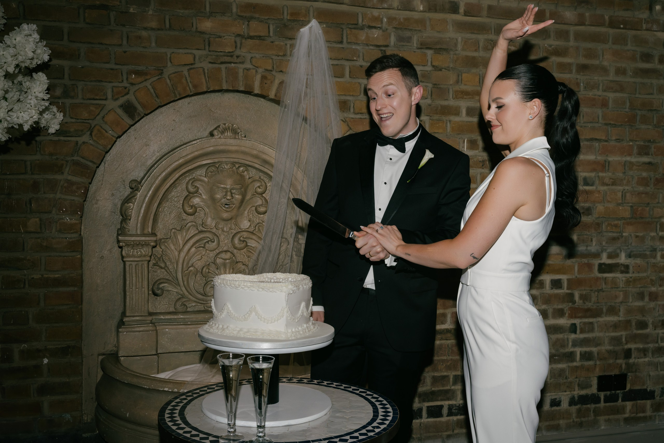 Bride and groom cutting the wedding cake at Friern Manor reception