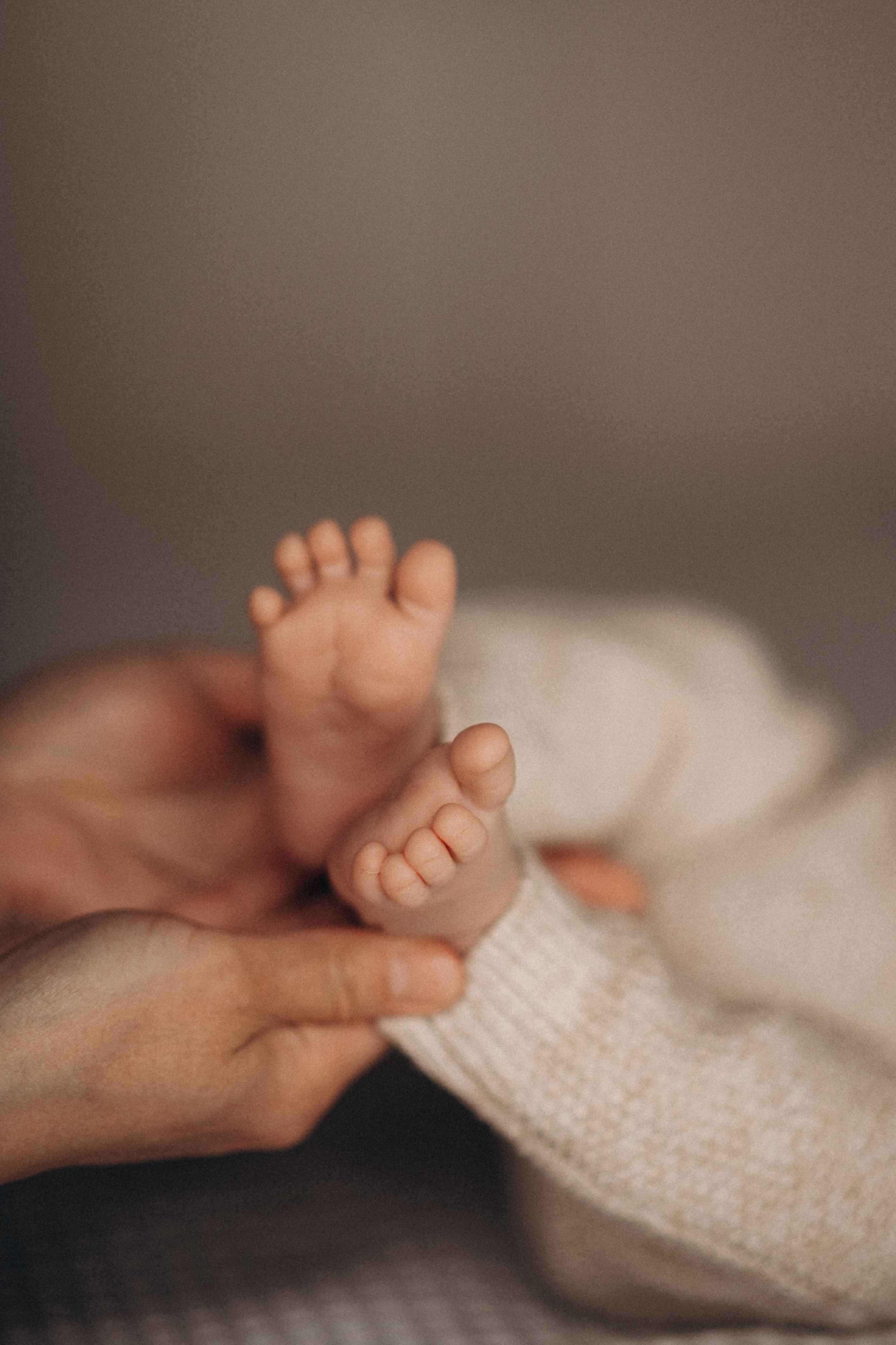 hands hold baby feet