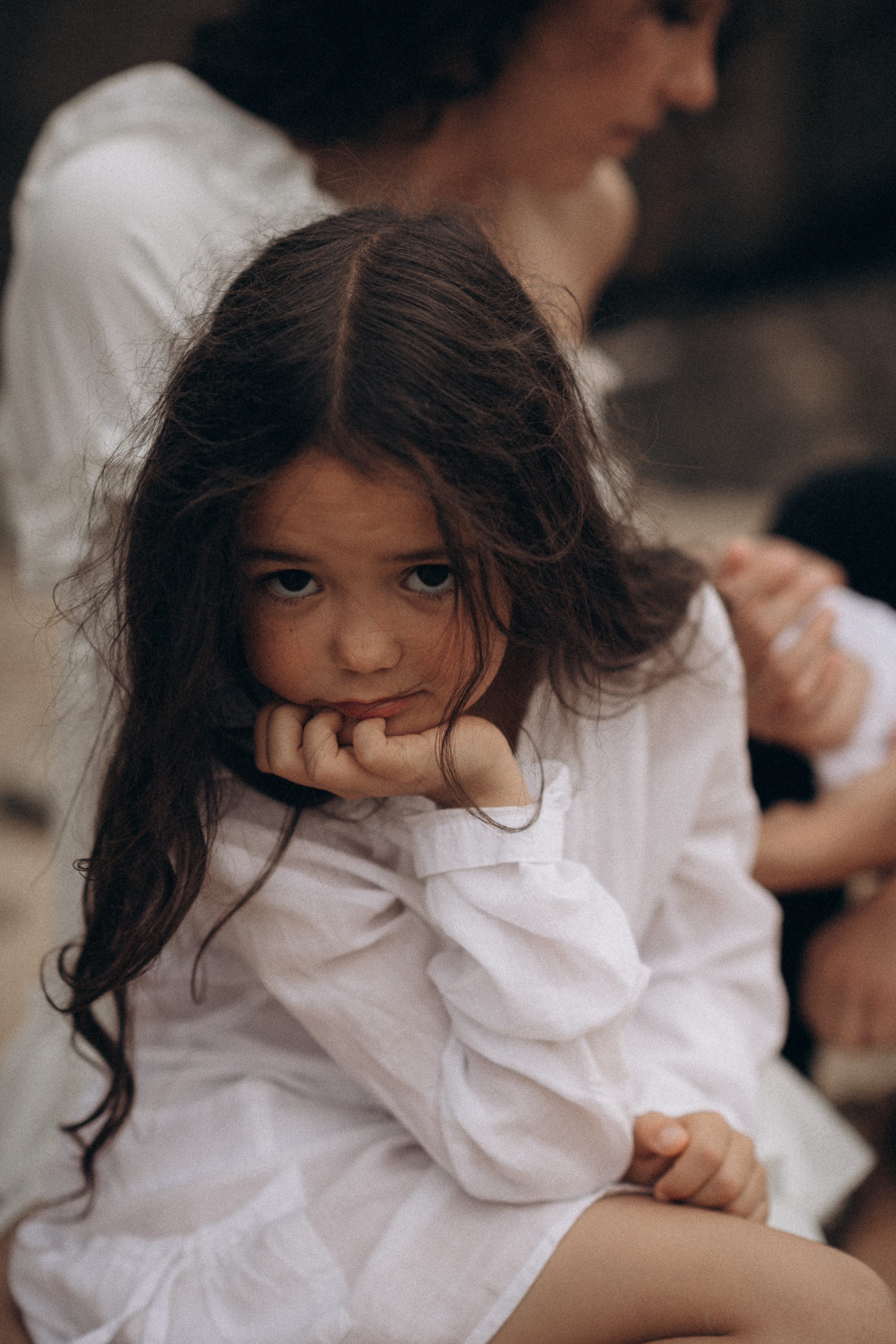 little girl sitting on the beach