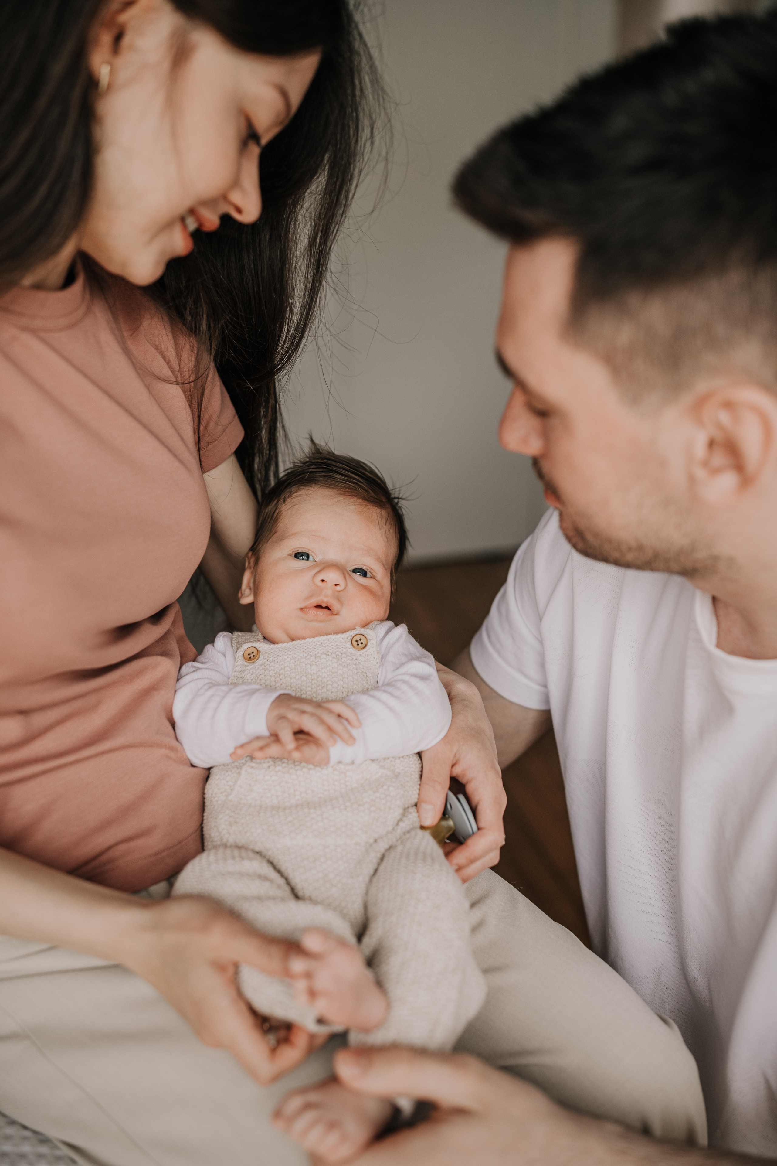 parents with their newborn baby at home