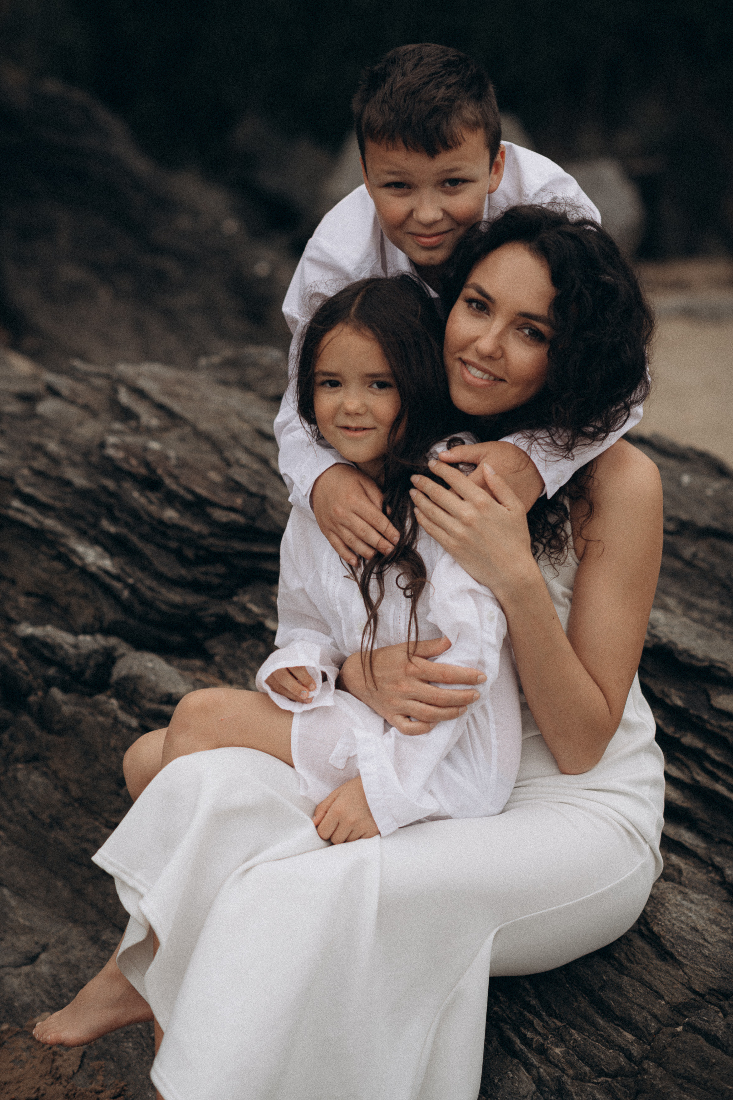 young mother with her kids portraits on the beach