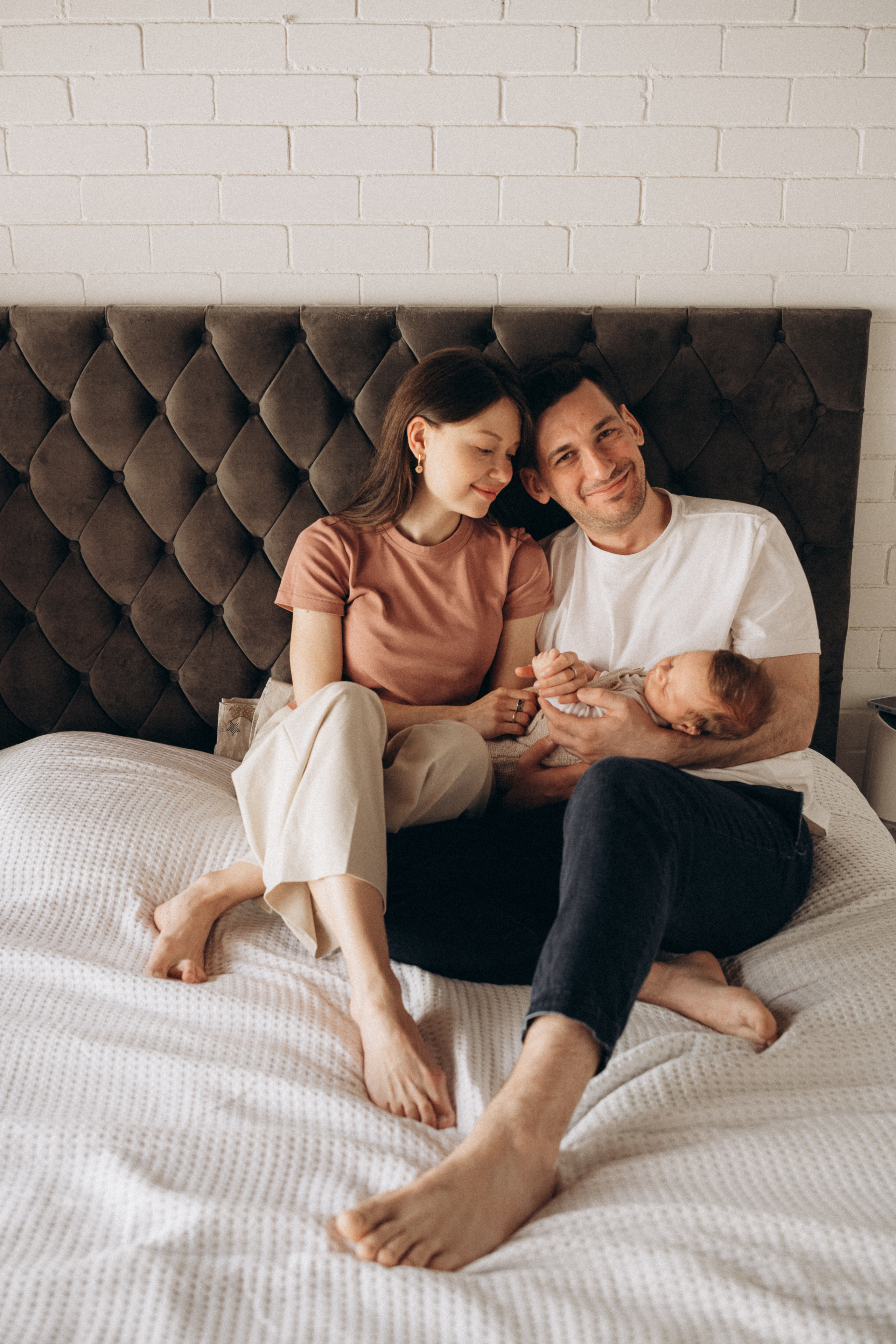 portrait of the family at home on the bed