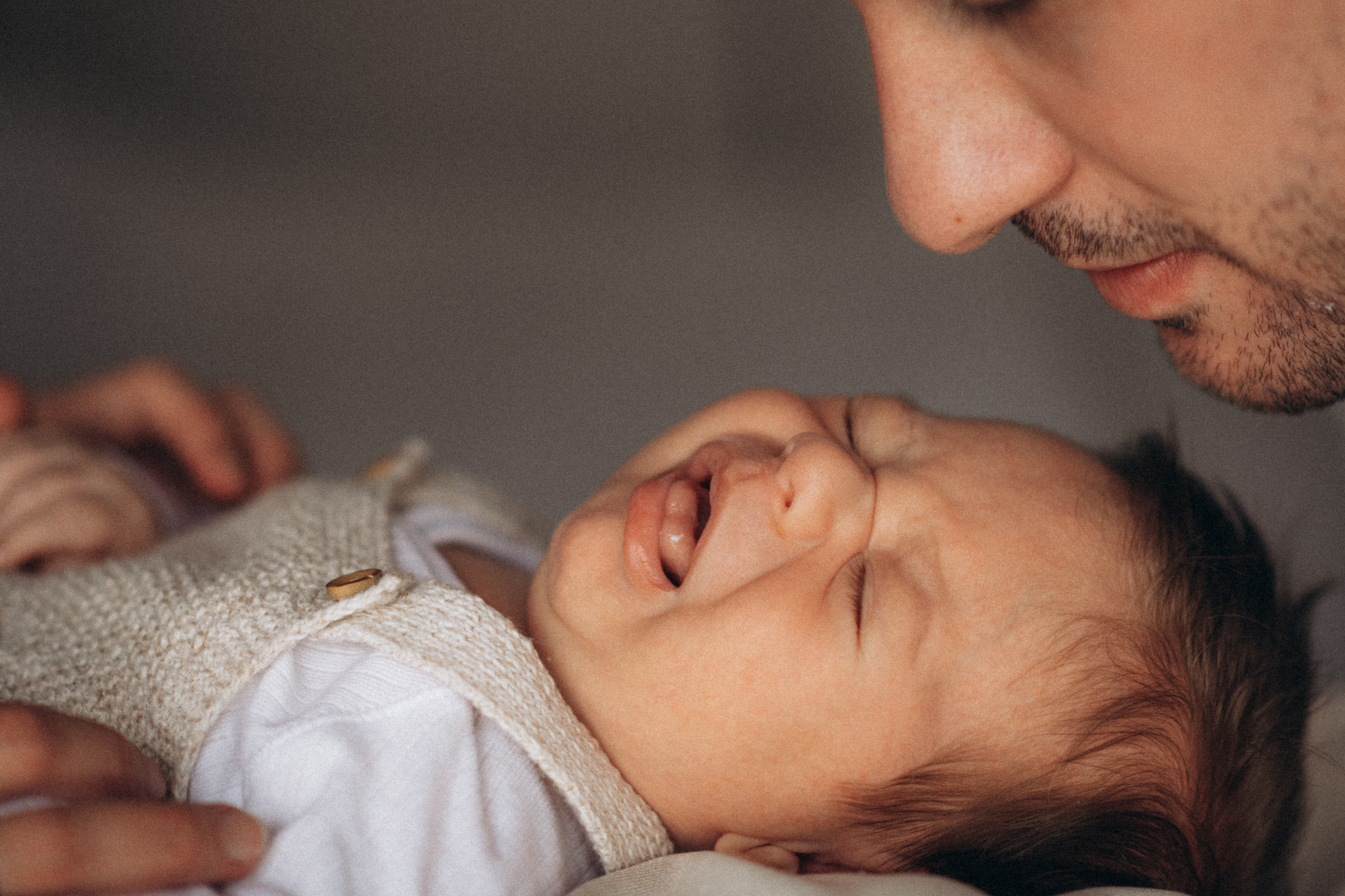 dad kissing his baby 