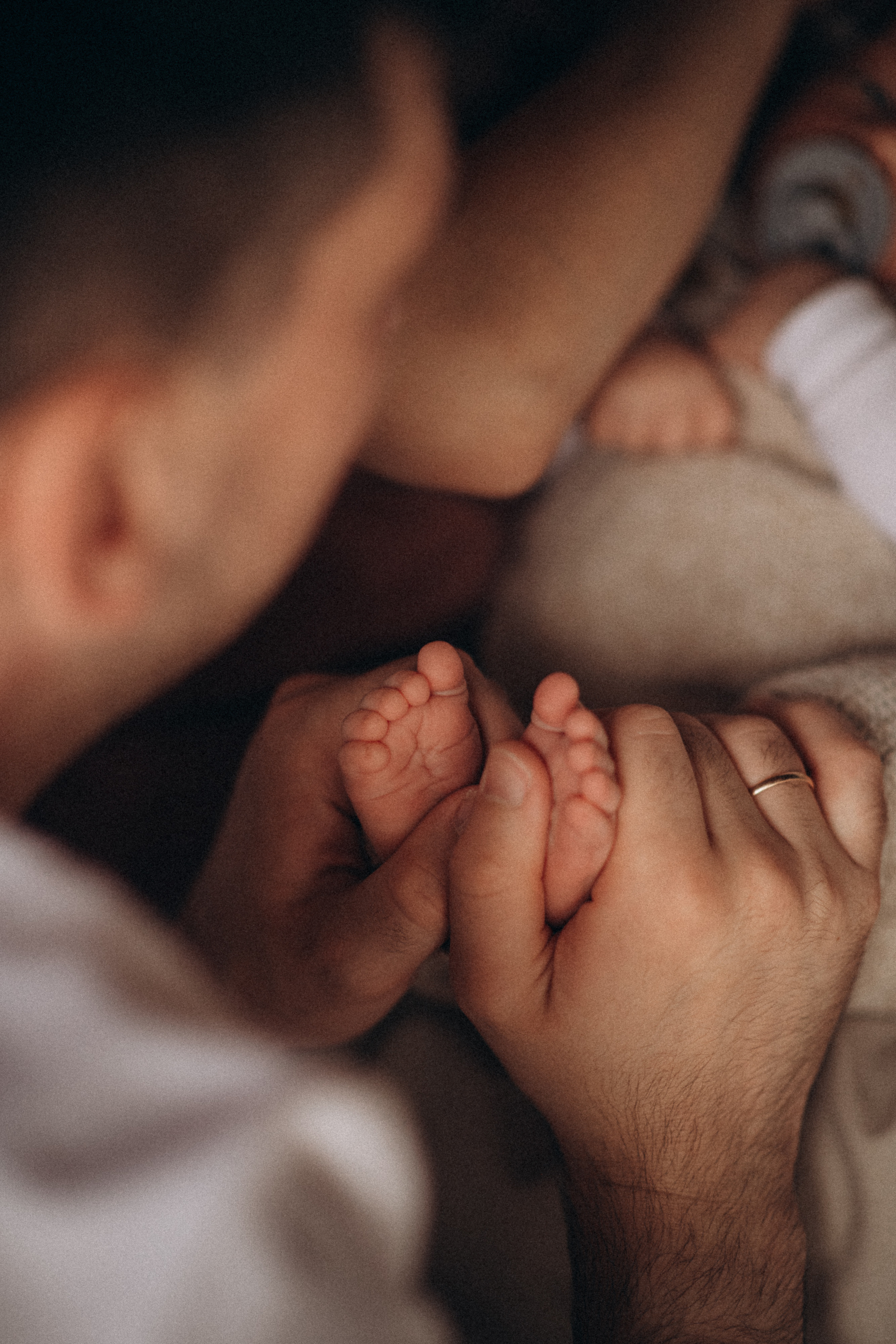 dad holds baby feet