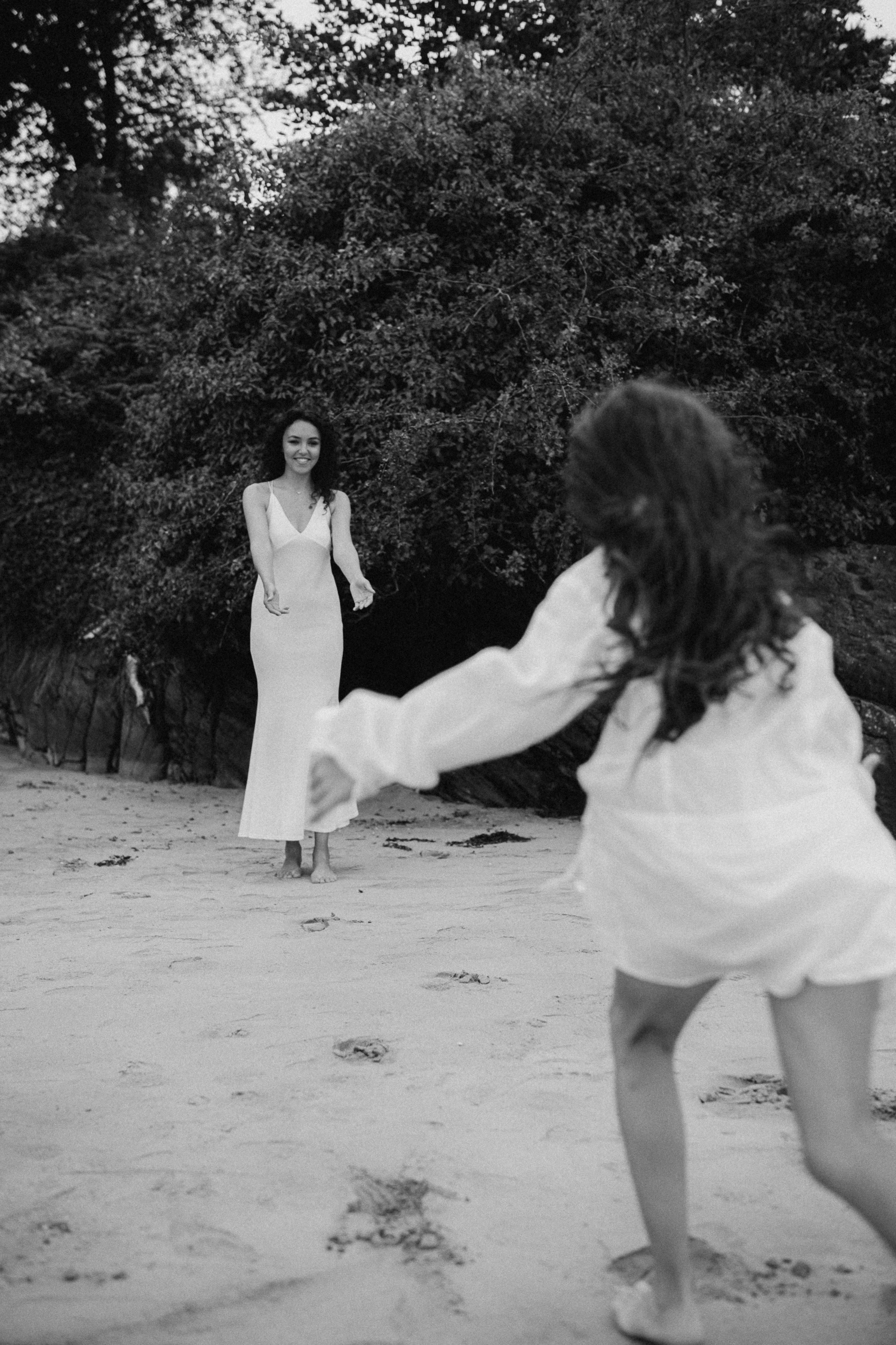 mother and daughter candid photo on the beach