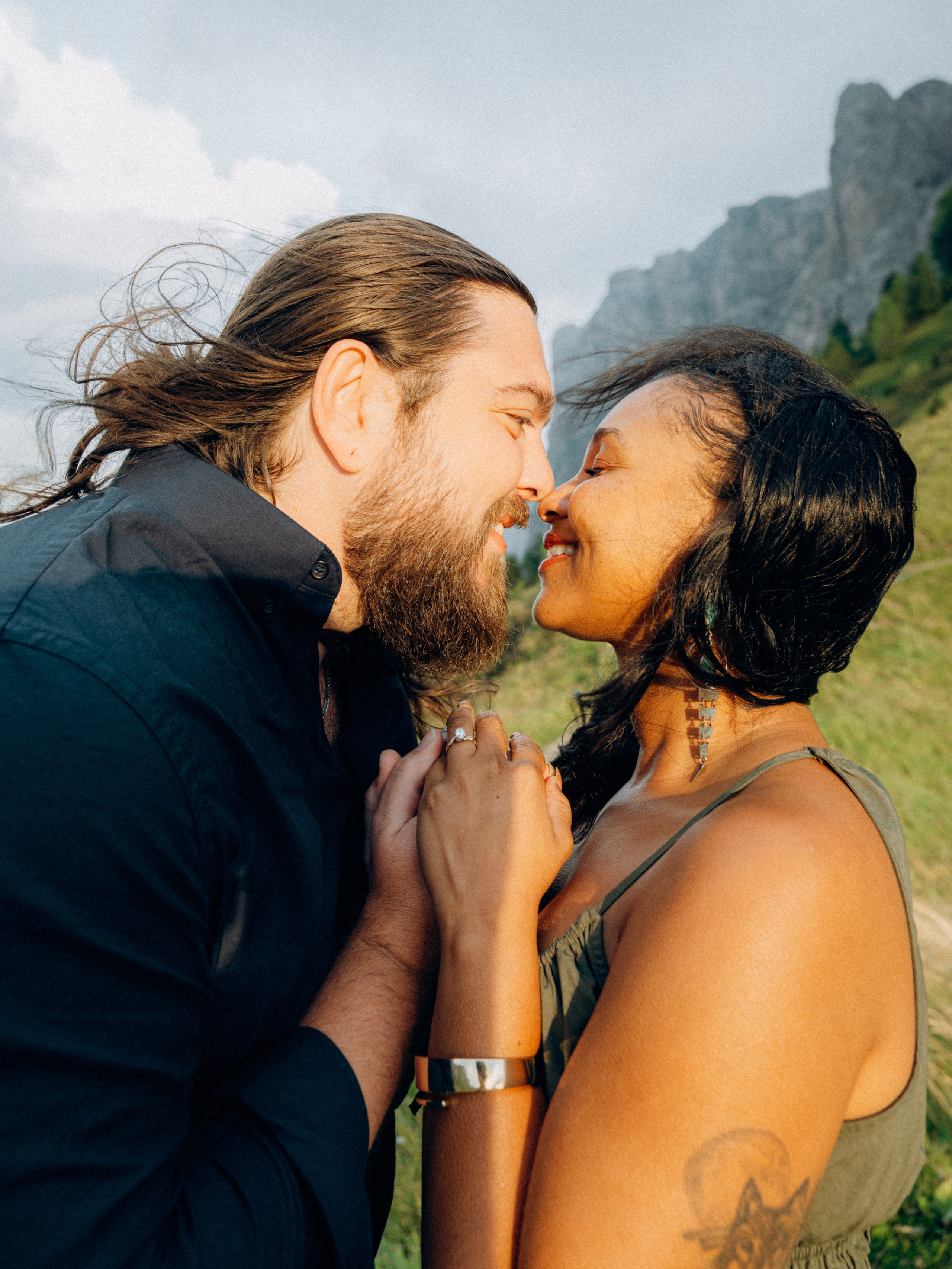 Close-up of engagement ring with Dolomites landscape softly blurred behind