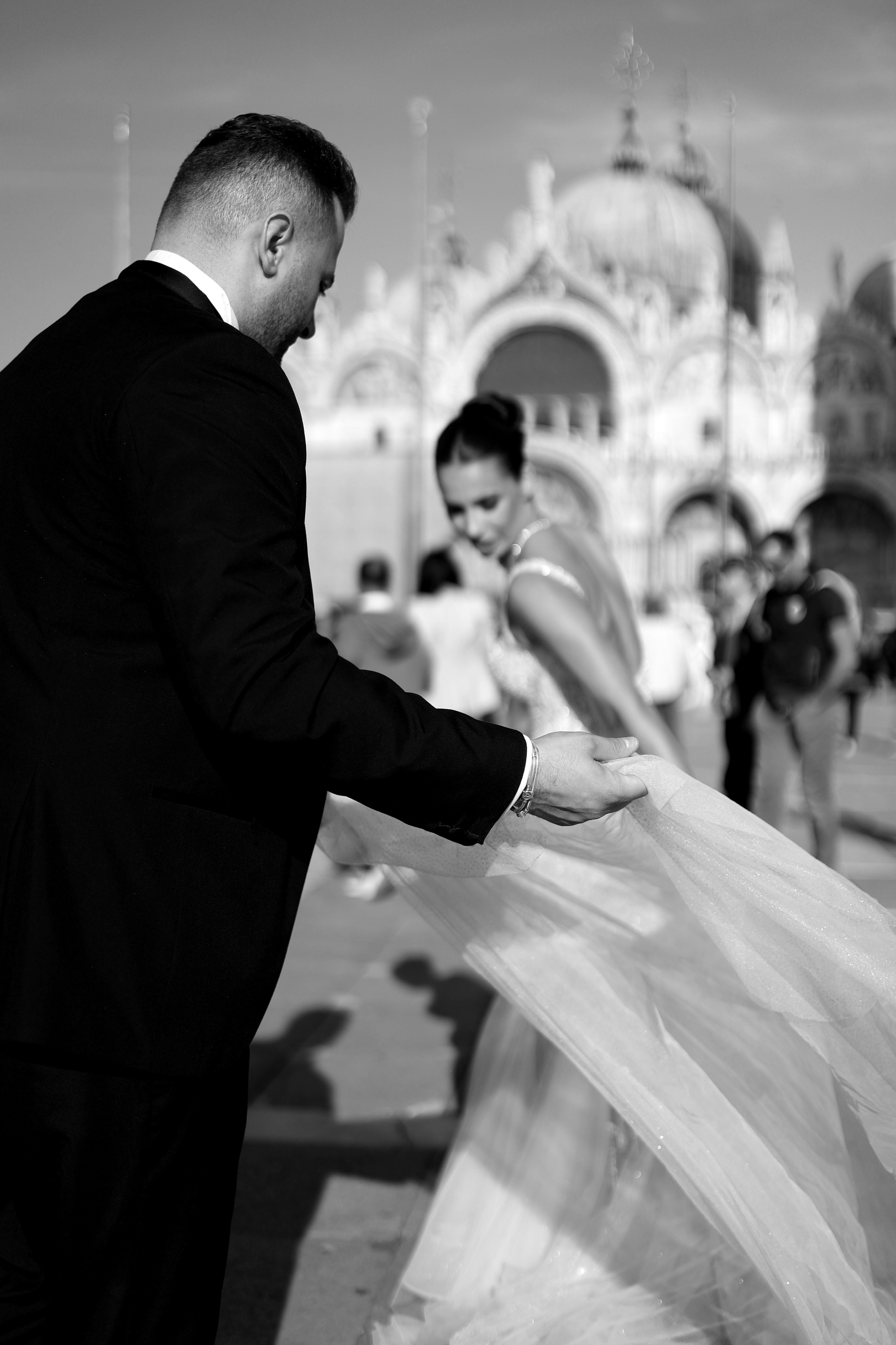 Bride and groom standing on a picturesque Venice square