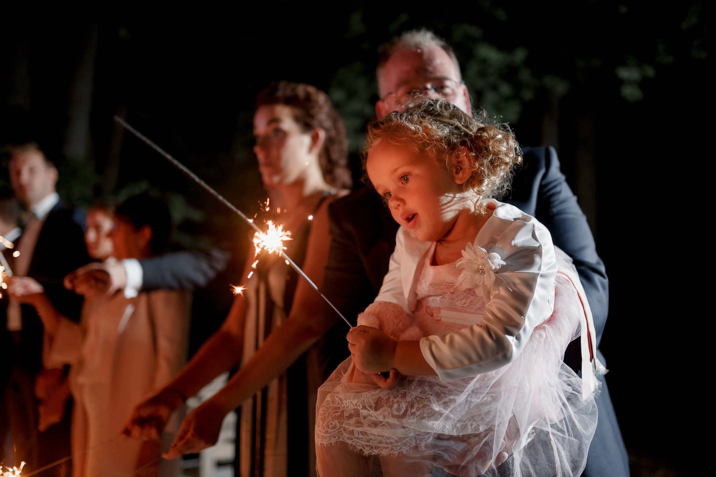 Kid with sparkler, by Bude, Cornwall reportage photographer.