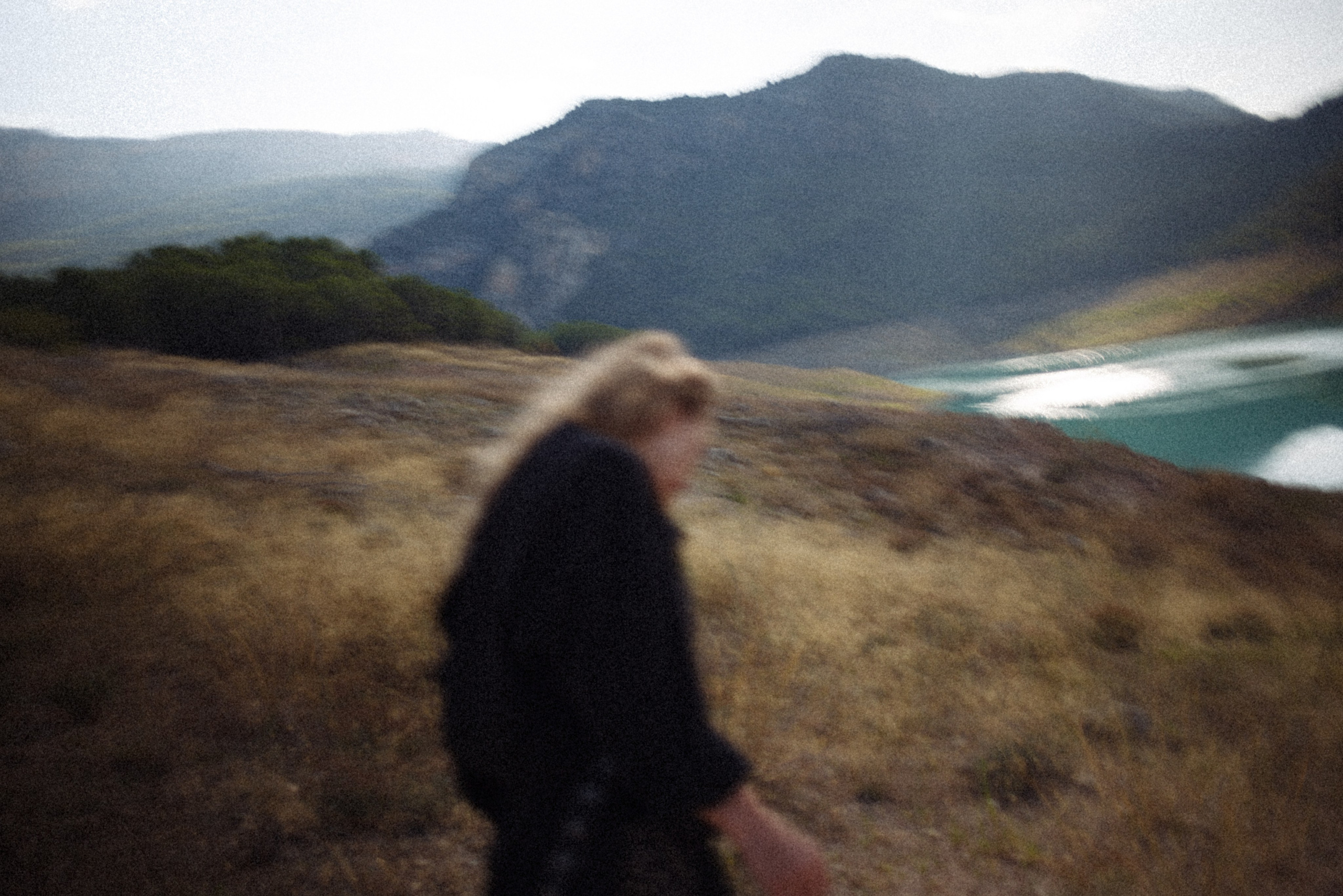 A solitary figure walking near a coastal landscape