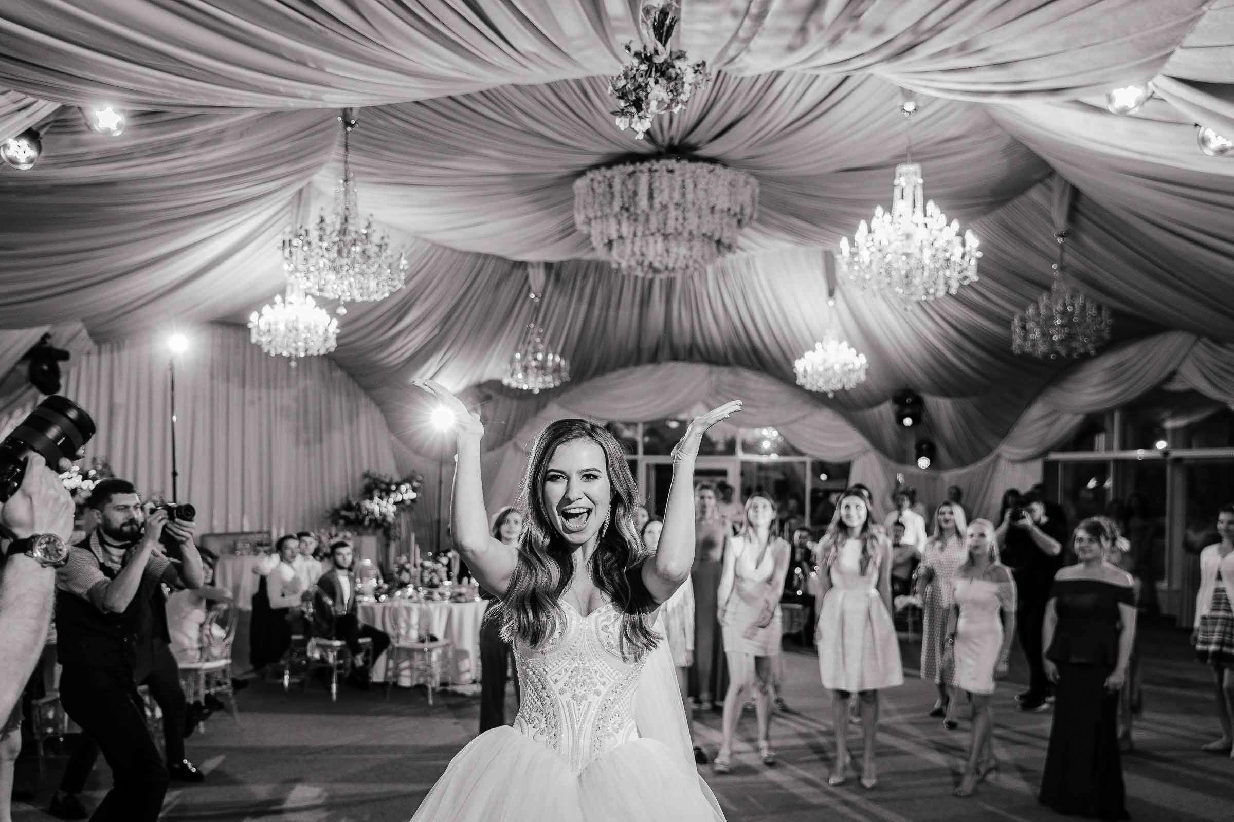 Bride tossing bouquet, by Tanya Bodgan, London wedding photographer.