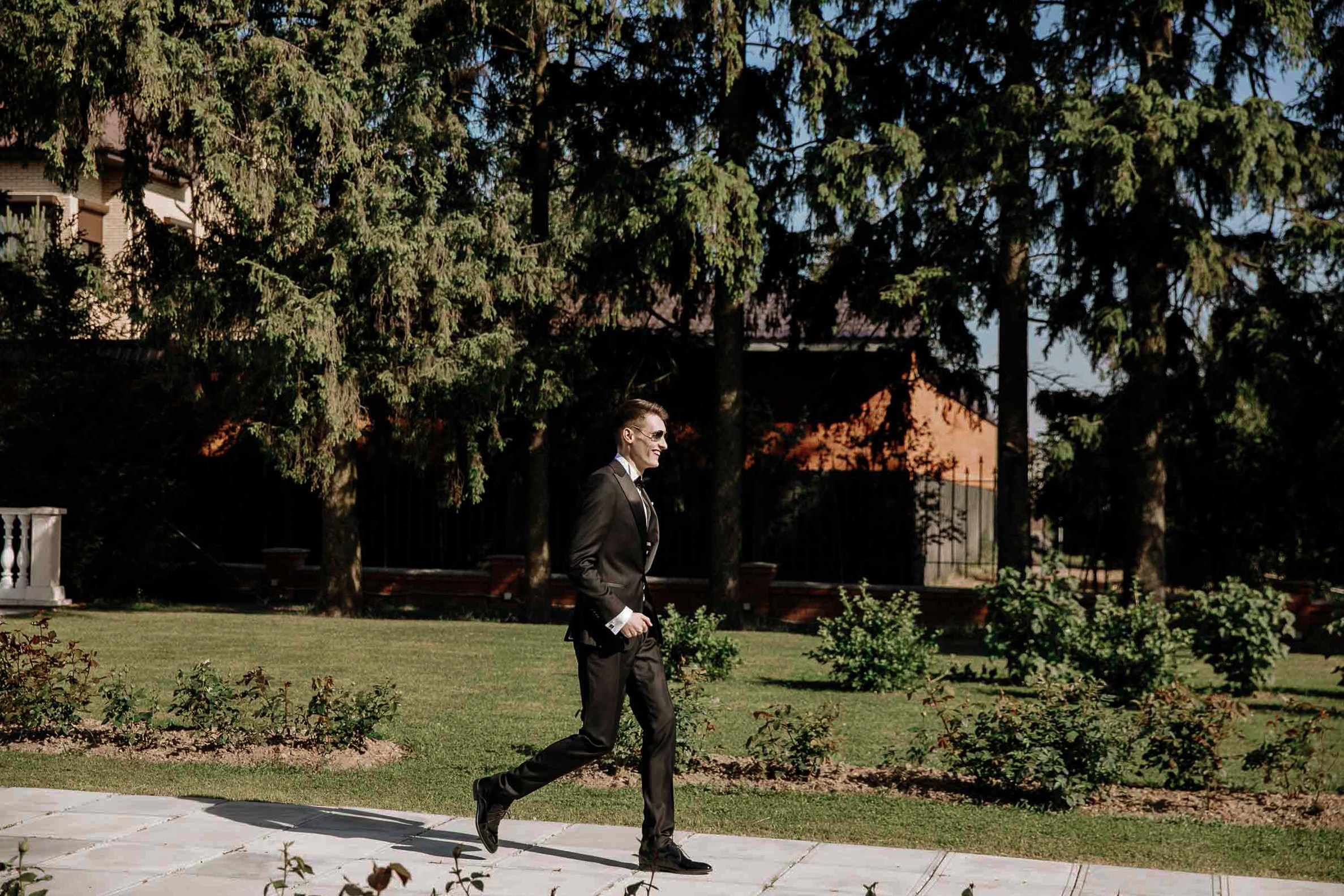 Groom walking, by Tanya Bodgan, Bude wedding photography.