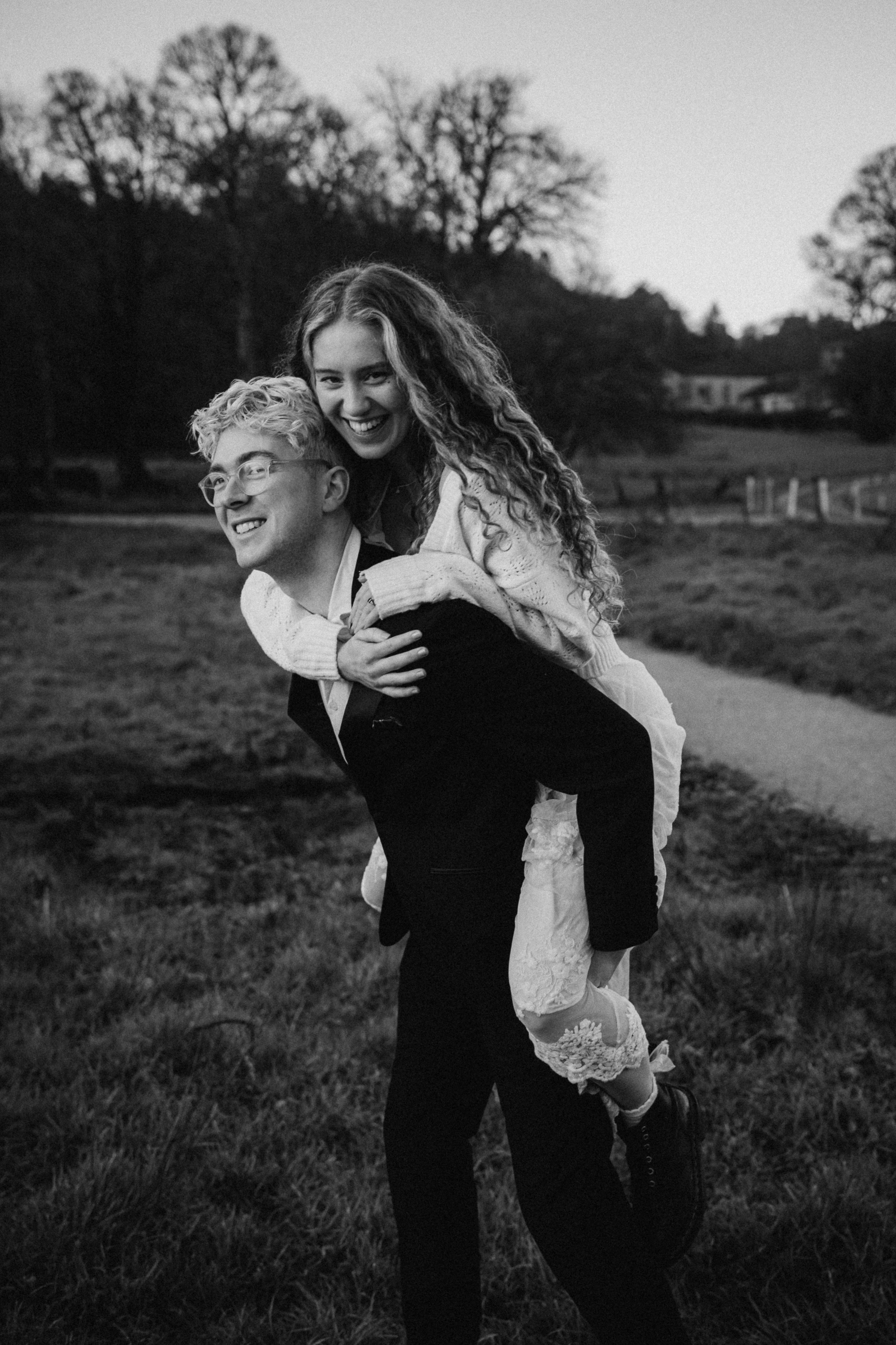 groom carries bride on his back