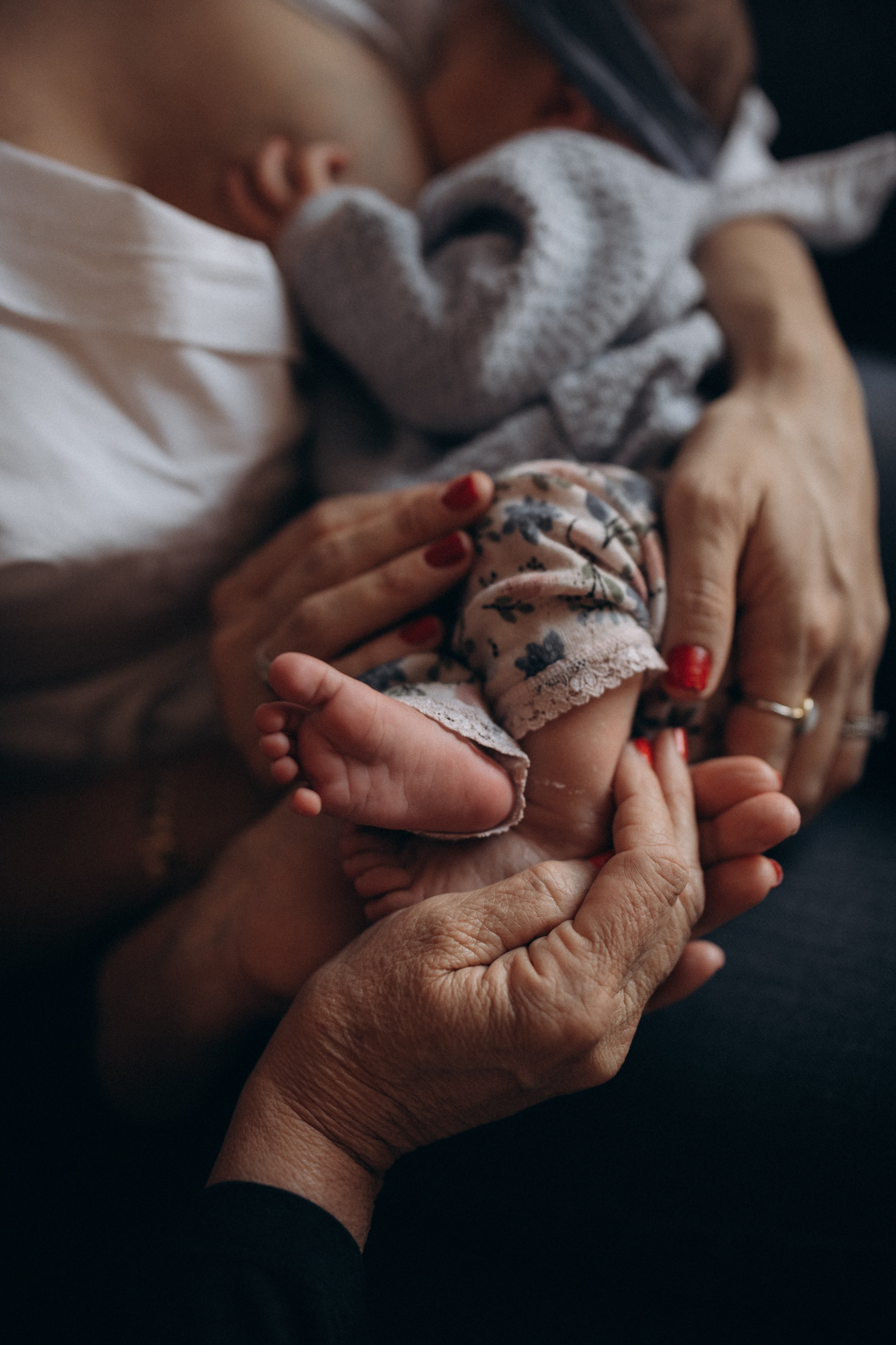 grandmother holds baby feet