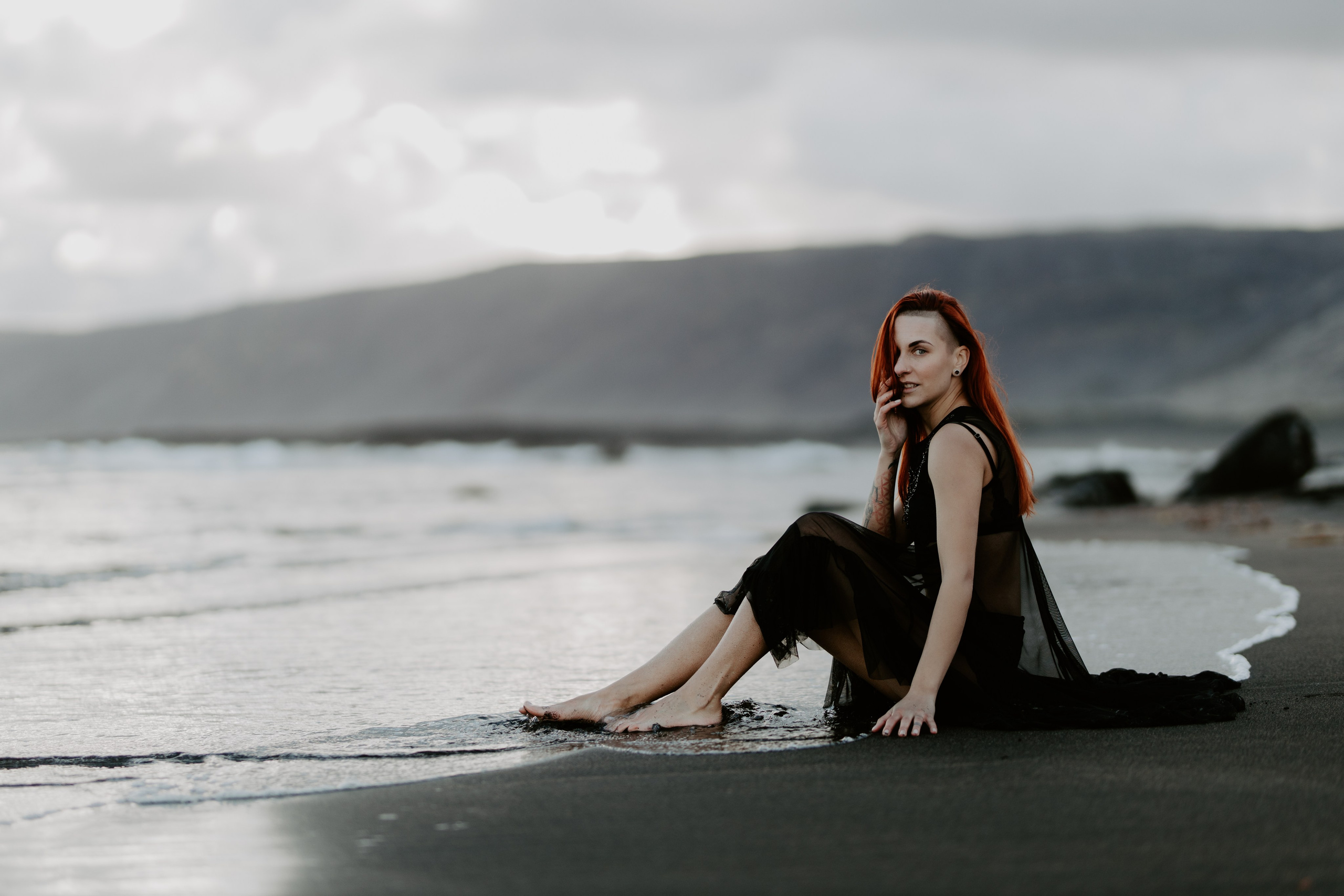 Empowering outdoor boudoir session in Iceland’s wild nature, embracing confidence and self-expression.