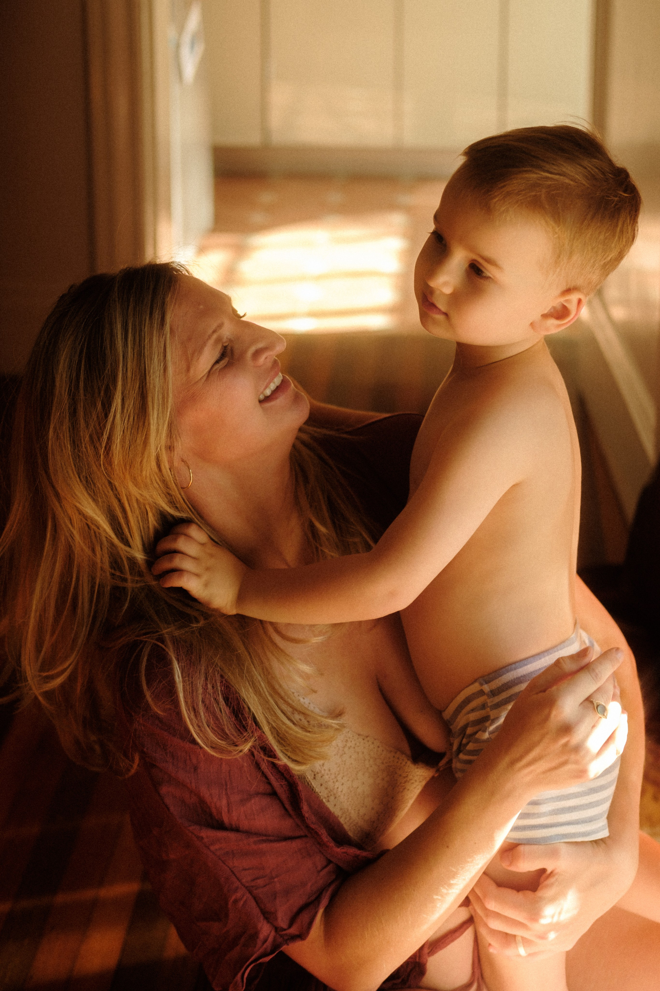 Intimate maternity moment with couple embracing, hands resting on baby bump, captured in Richmond, VA.