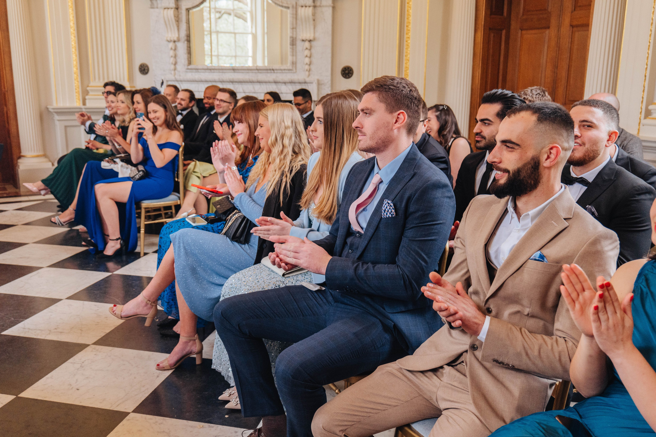 guests clapping hands at the wedding ceremony start