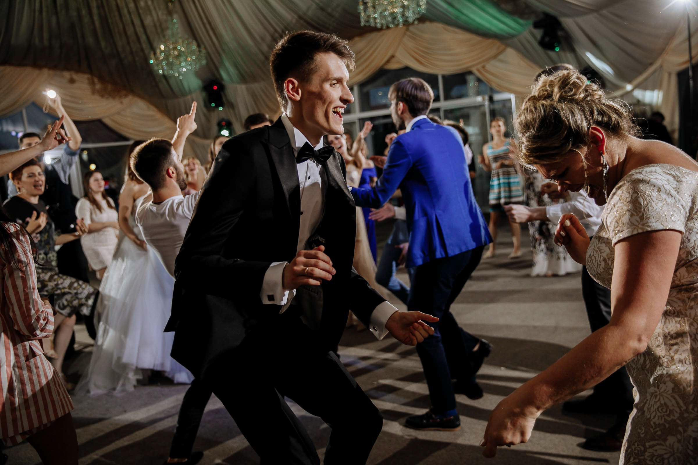 Groom dancing candid, by Tanya Bodgan, Bude, Cornwall wedding photography.