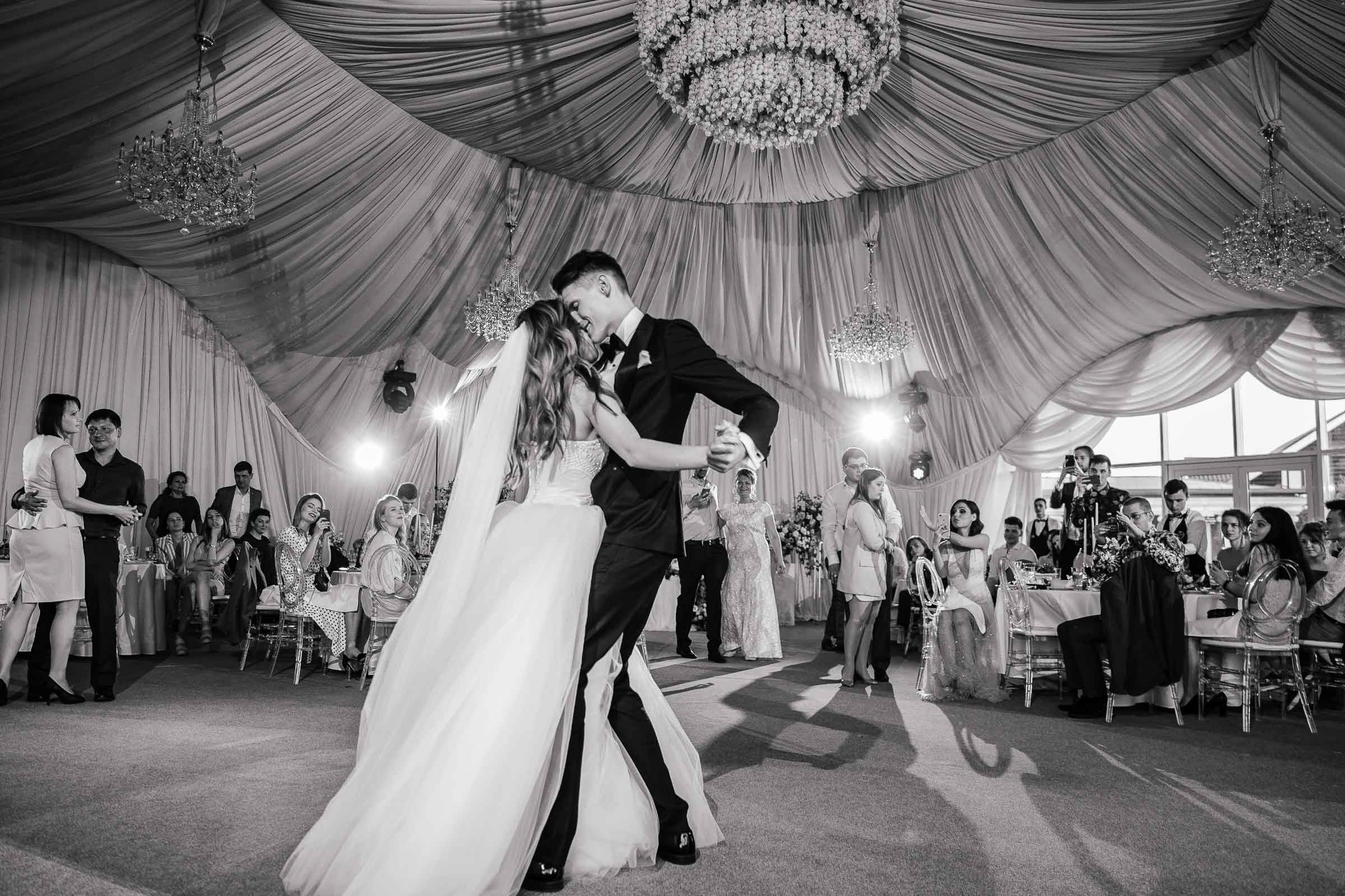 Bride and groom walking in gardens by grand house, by Tanya Bodgan, Bude, Cornwall wedding photographer.