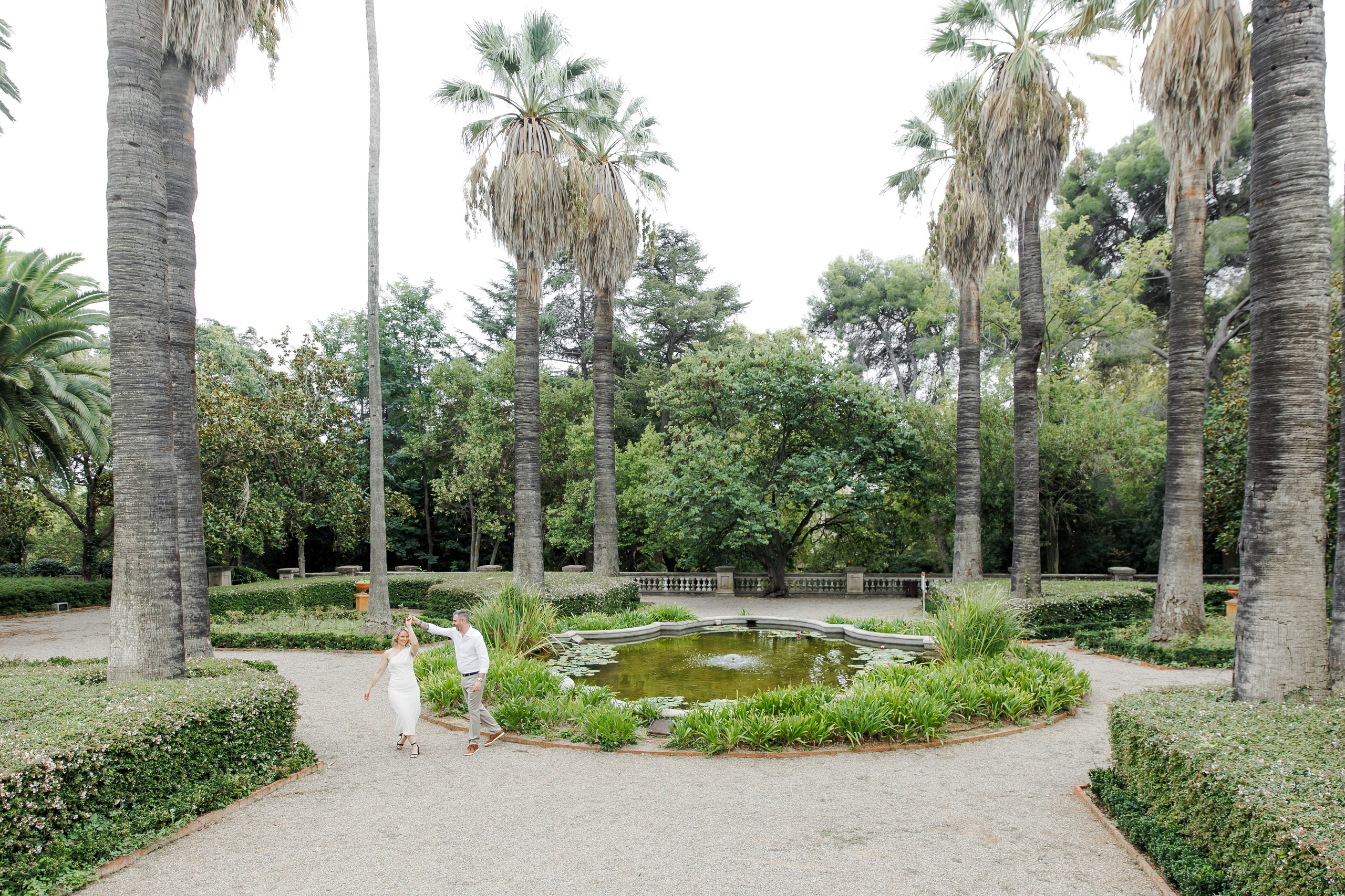 Bride and groom dance in the green park of Barcelona