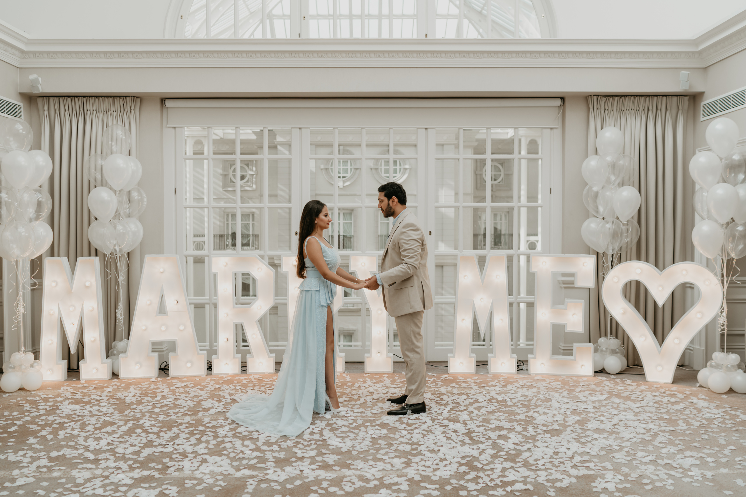 young man is making proposal to his fiancé 