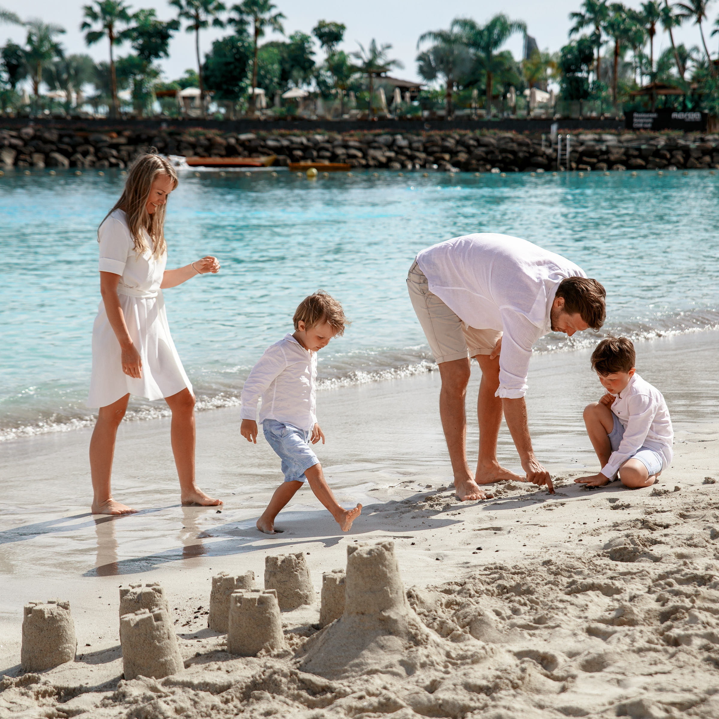 Une famille jouant dans le sable sur la plage Photographe Anfi