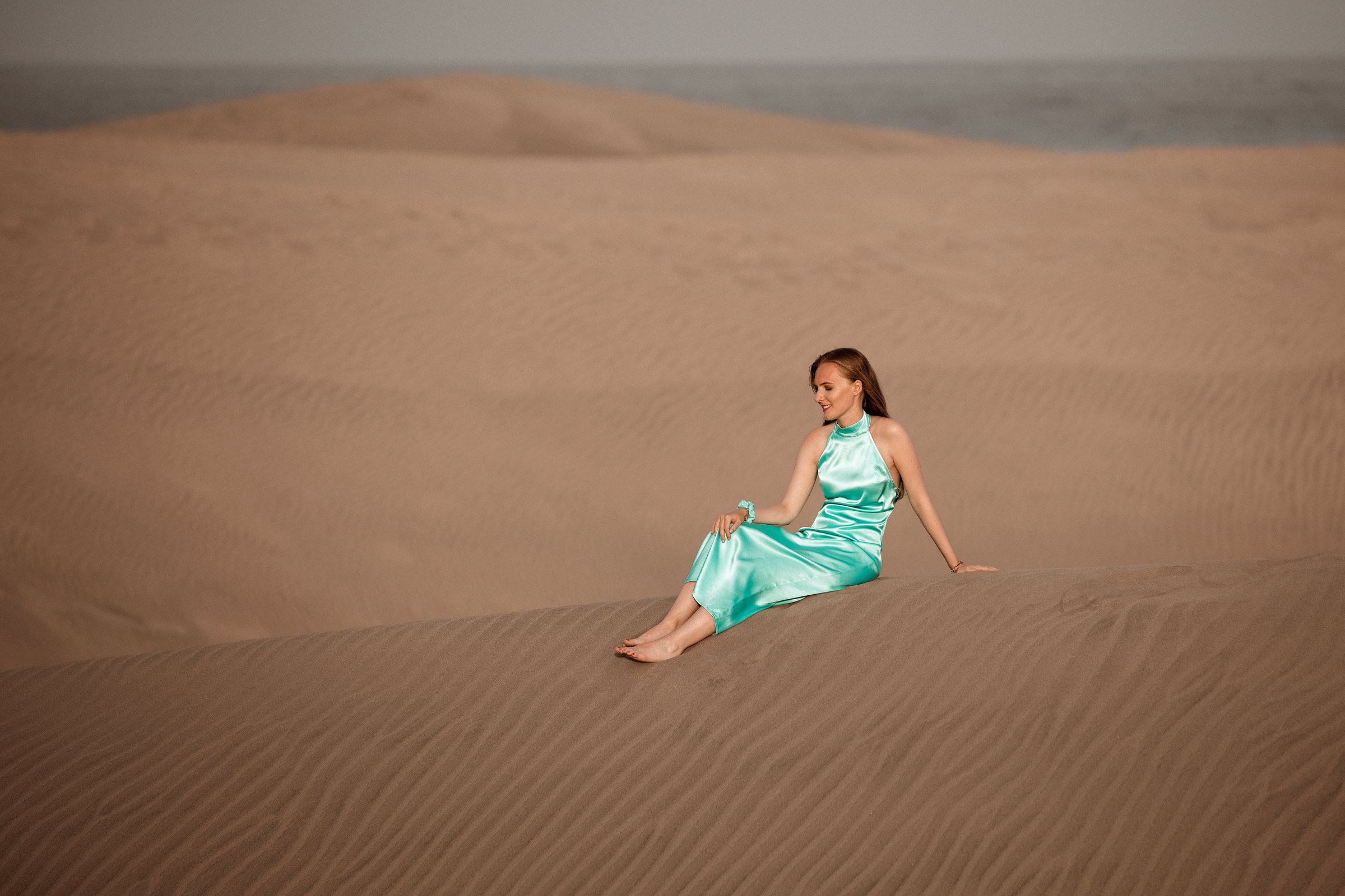 Discover the allure of Maspalomas with Photographer Gran Canaria and a captivating woman in a blue dress on the sand dunes