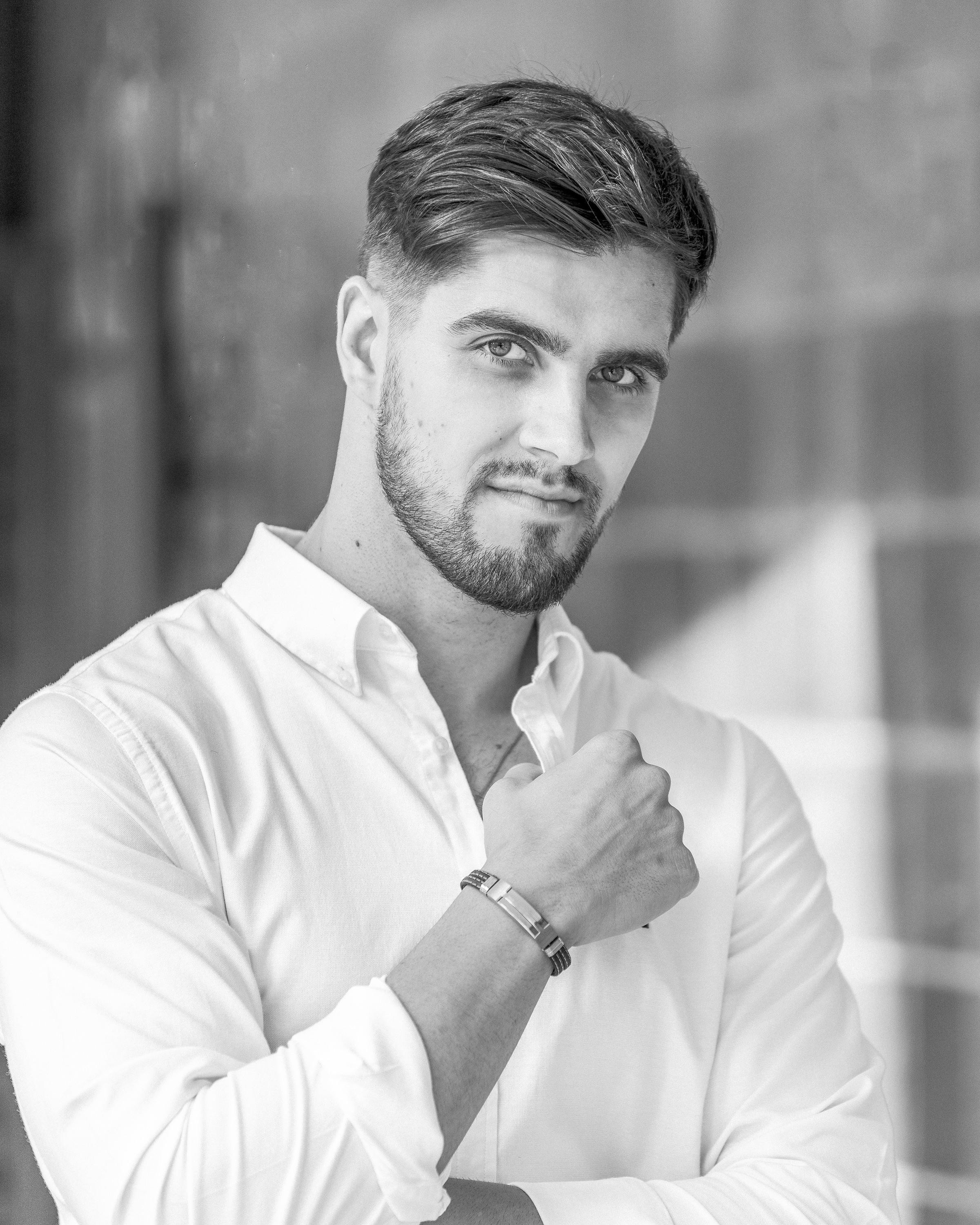 A black and white photo of a man in a white shirt.