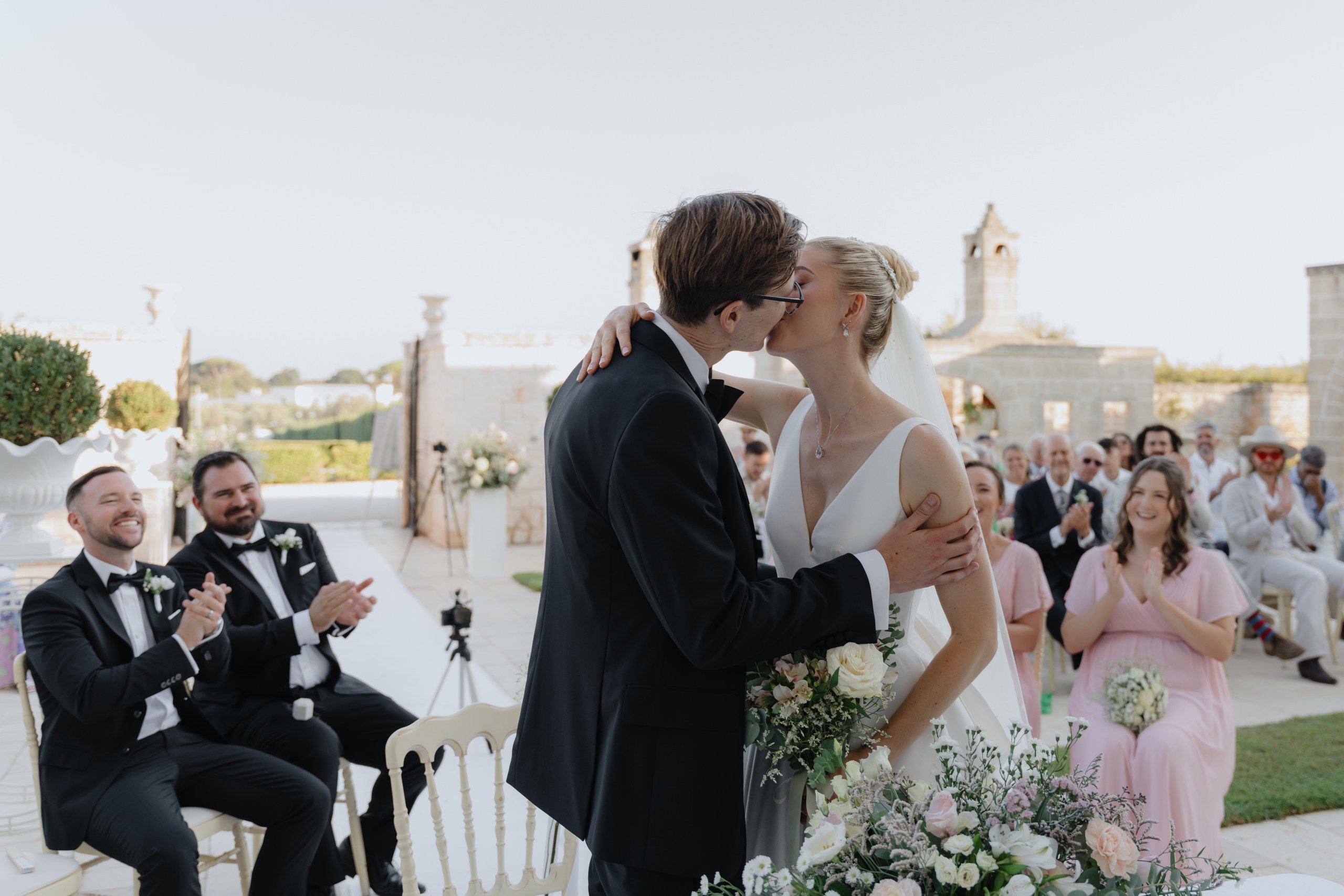 Bride and groom exchanging vows in courtyard of Masseria Traetta Exclusive