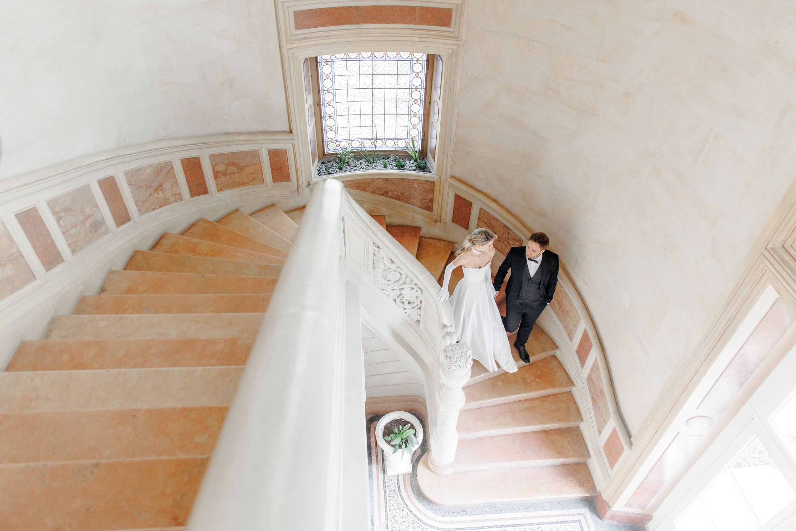 Bride embracing her groom in a romantic French setting, capturing love and joy on their wedding day.