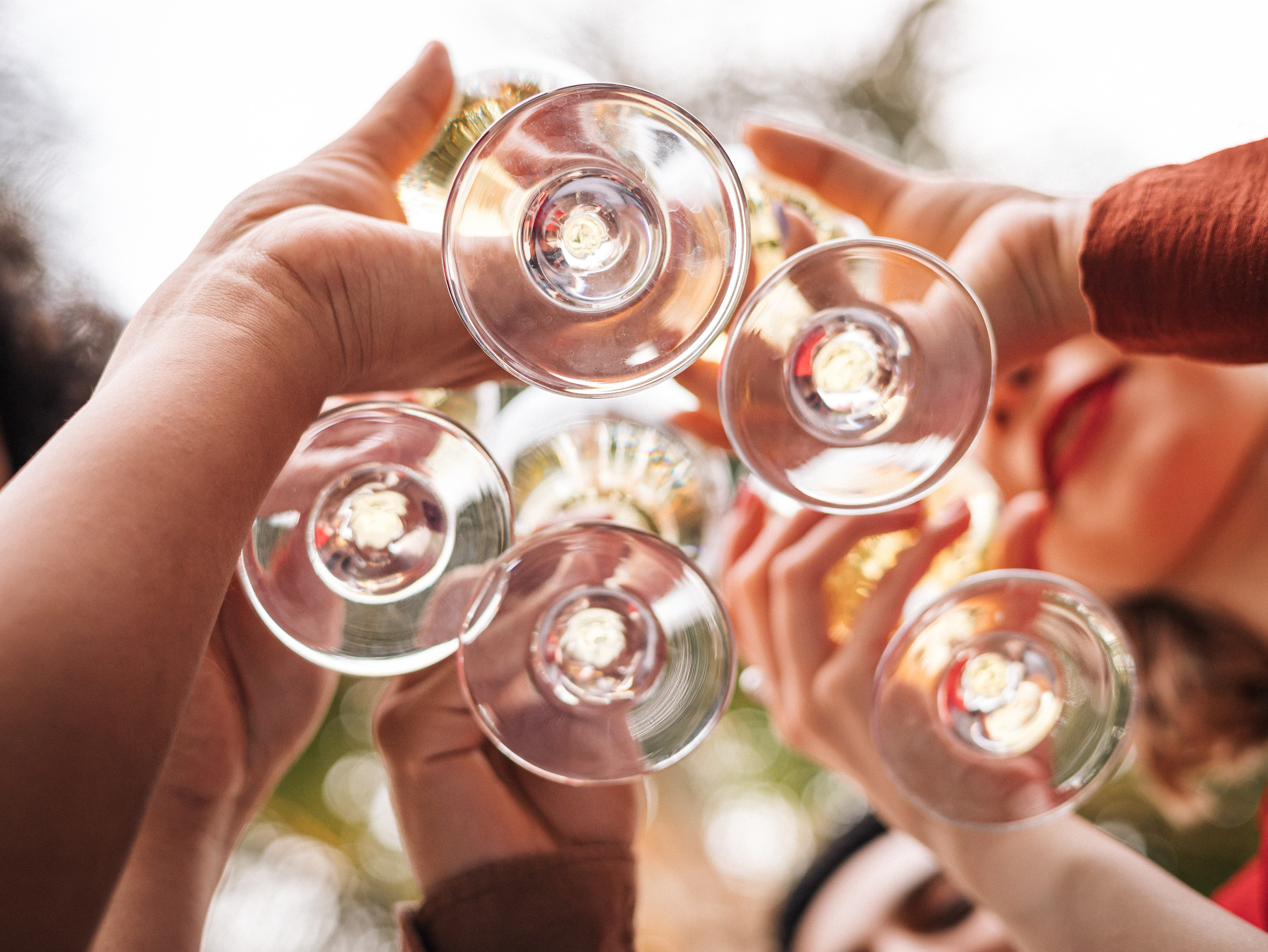 Cheers friends clinking glasses at the birthday celebration
