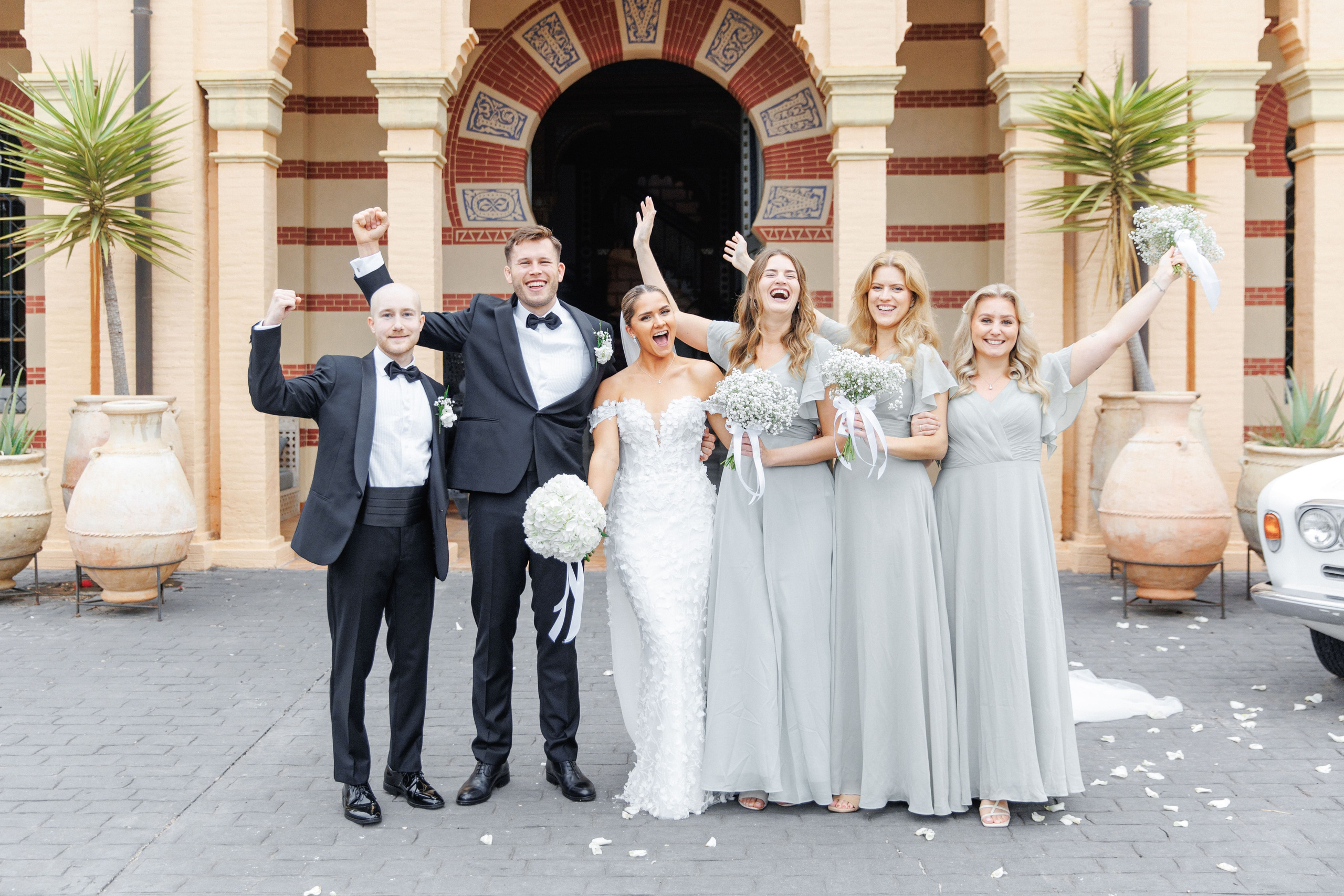 Wedding guests dressed in elegant formal attire, showcasing their style at a destination wedding in Barcelona.