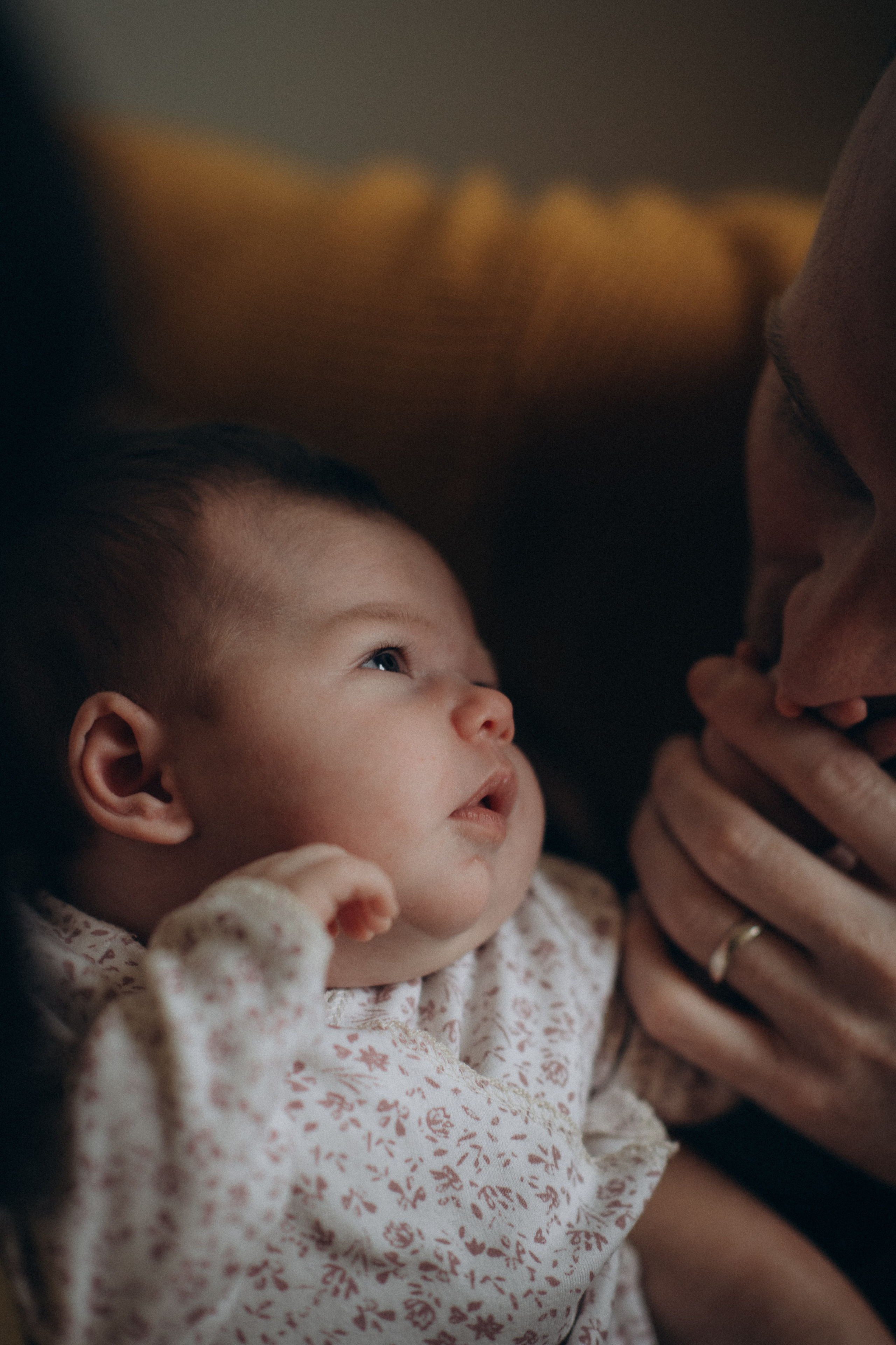 tiny baby looking at her mother