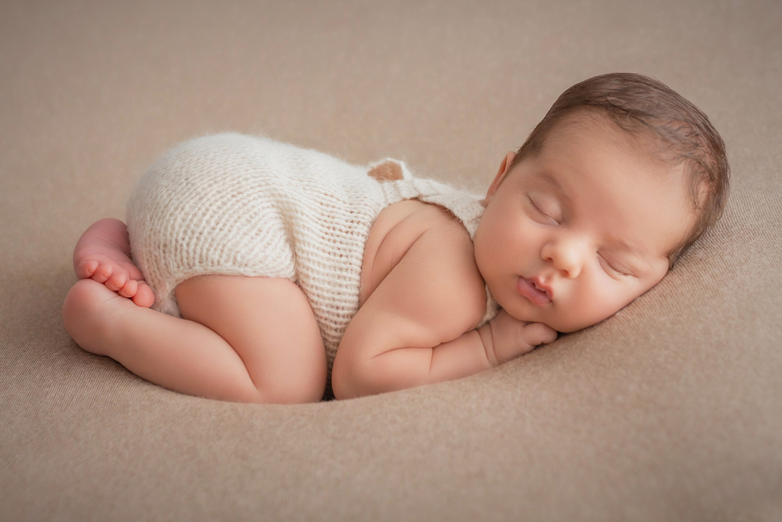 Newborn baby sleeping peacefully on stomach